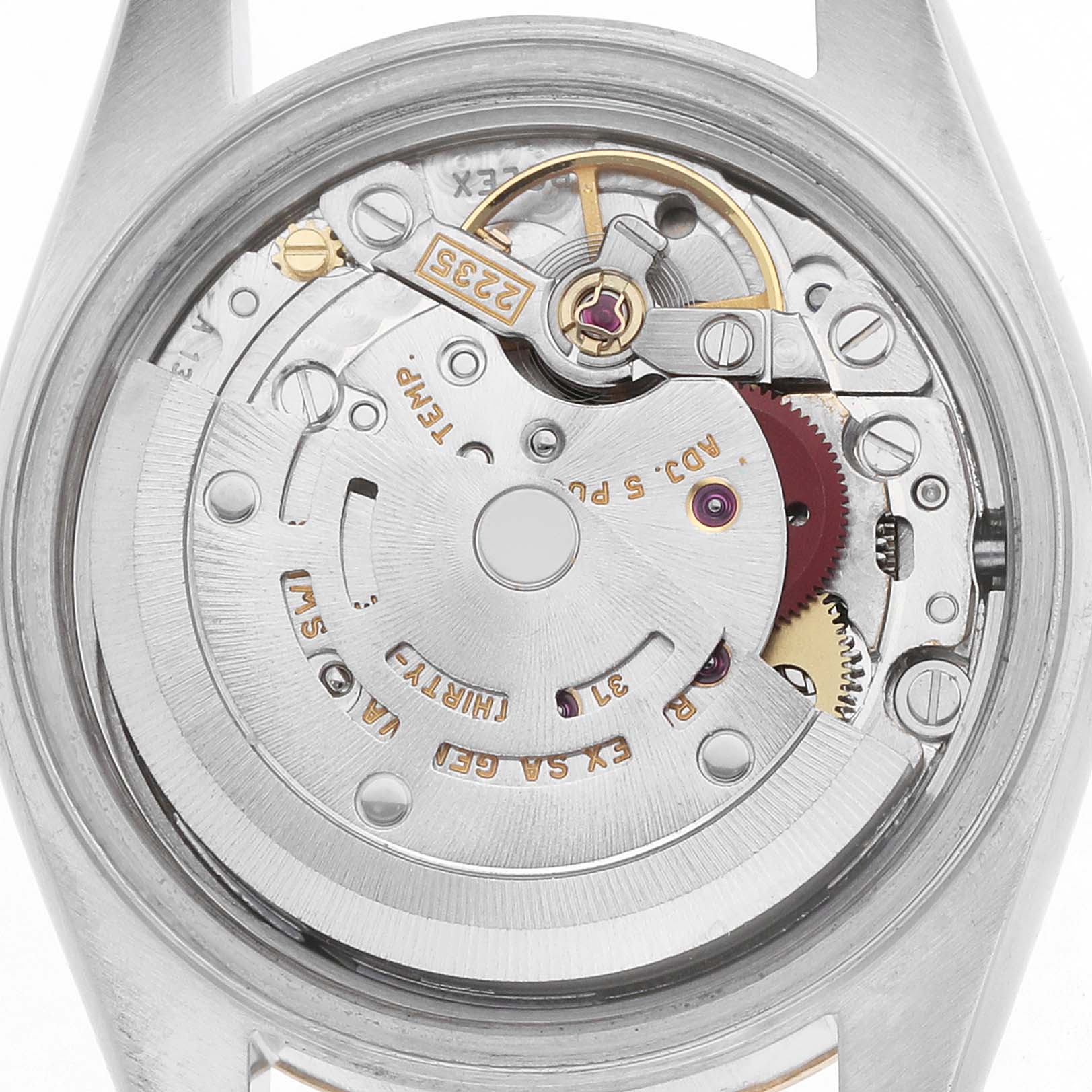 The image shows a close-up of the Rolex Datejust 79173 Women
s Steel and Gold (two tone) Champagne Dial movement, highlighting gears, rotor, and mechanical components.