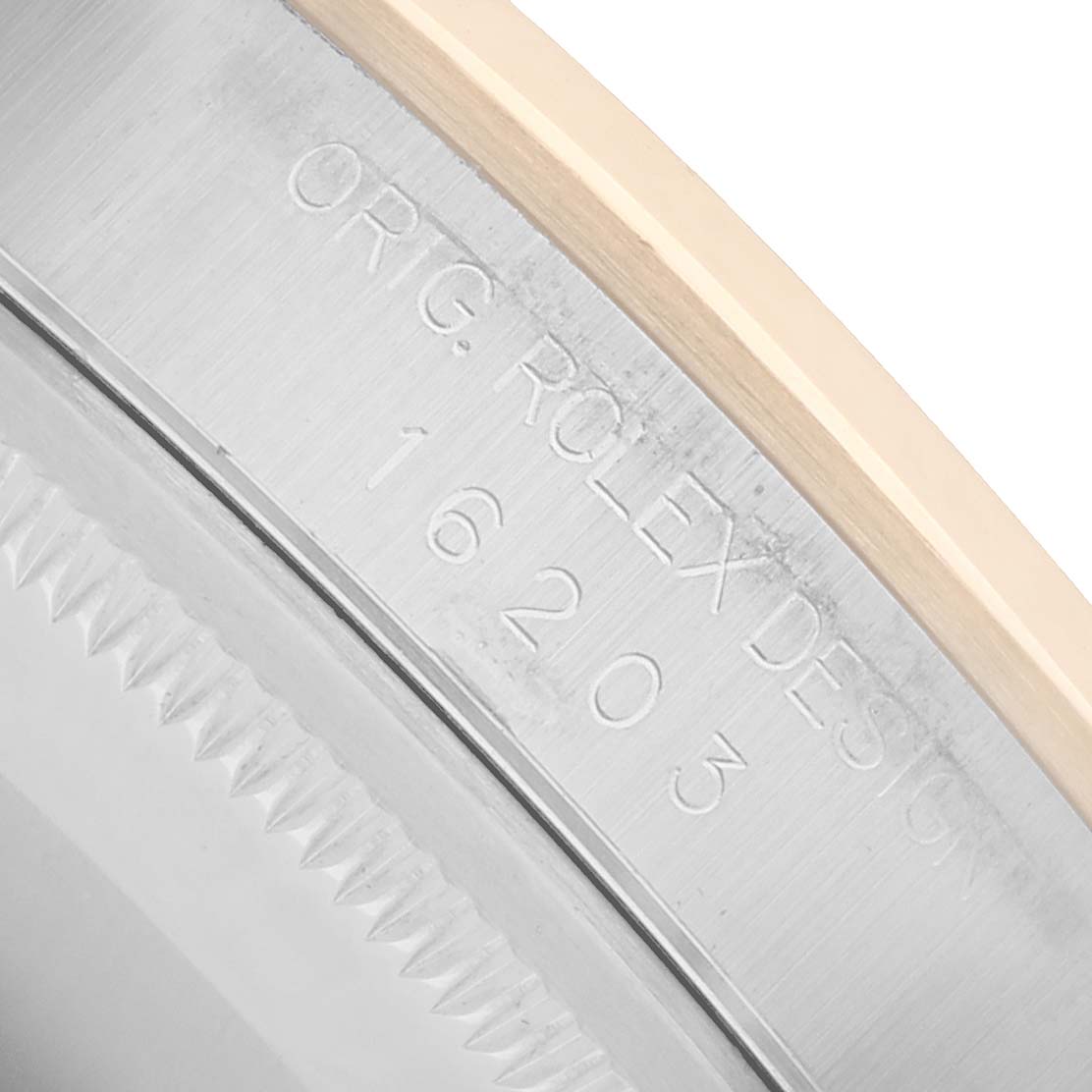 The image shows a close-up of the Rolex Datejust 16203 Men
s Steel and Gold (two tone) Silver Dial
s bezel and case side, focusing on engraved model details.