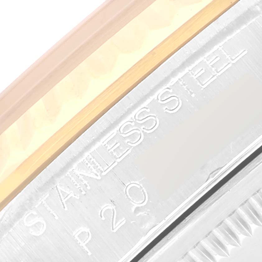 This close-up image shows the side of a Rolex Datejust 16233 Men's Steel and Gold (two tone) Mother of Pearl Dial 16233 Men's Steel and Gold (two tone) Mother of Pearl Dial watch, focusing on the "STAINLESS STEEL" and model number engravings.