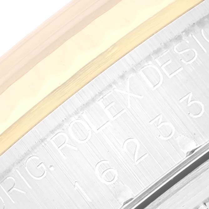 The image shows a close-up of the side of a Rolex Datejust 16233 Men's Steel and Gold (two tone) Mother of Pearl Dial 16233 Men's Steel and Gold (two tone) Mother of Pearl Dial watch, revealing part of the bezel and engraved model details.