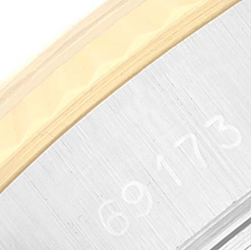 This close-up image shows part of the bezel and the side of the case of a Rolex Datejust 69173 Women's Steel and Gold (two tone) Silver Dial 69173 Women's Steel and Gold (two tone) Silver Dial watch.