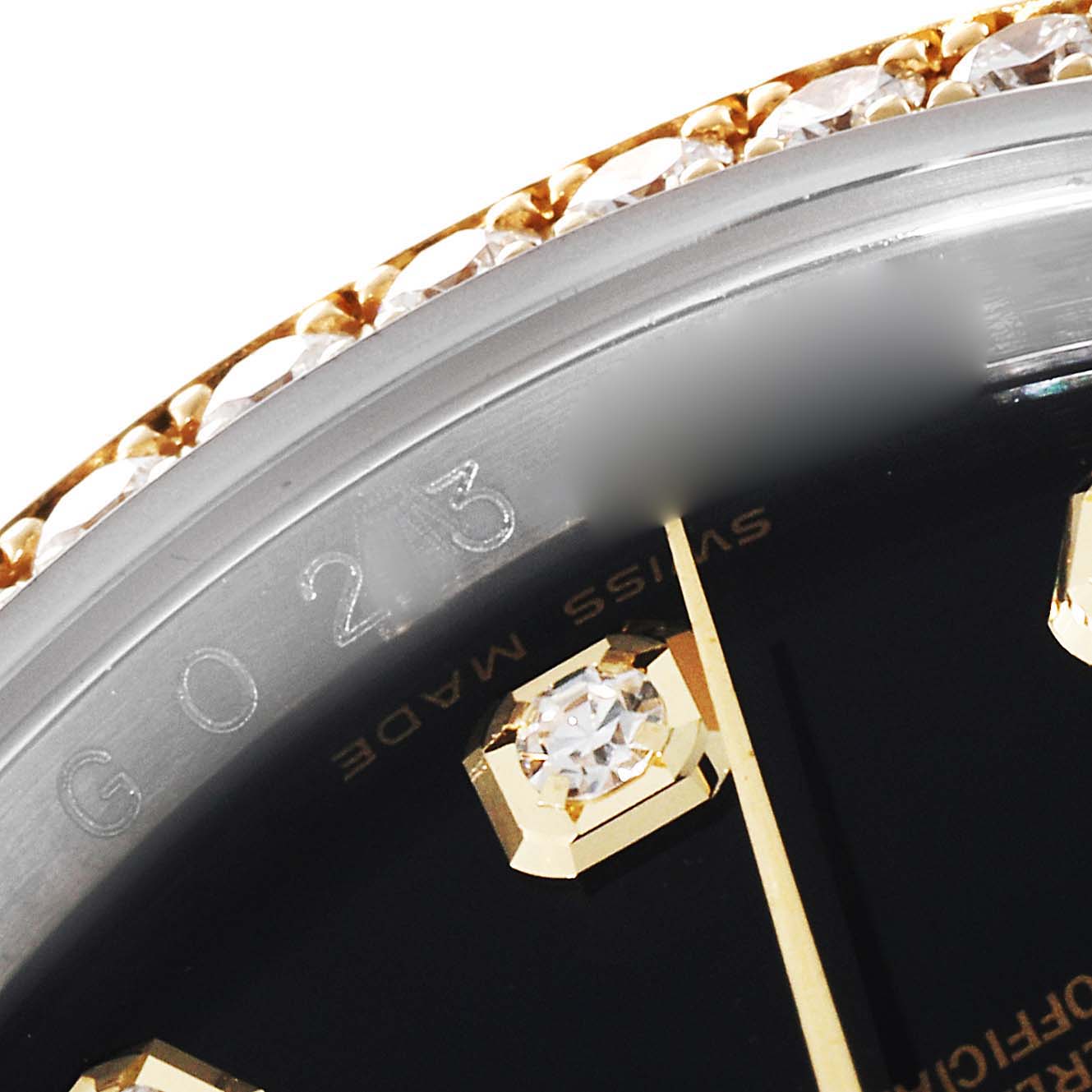 This close-up angle of the Rolex Datejust 116243 Men's Steel and Gold (two tone) Black Dial 116243 Men's Steel and Gold (two tone) Black Dial watch shows the bezel and a portion of the dial with diamond indices.