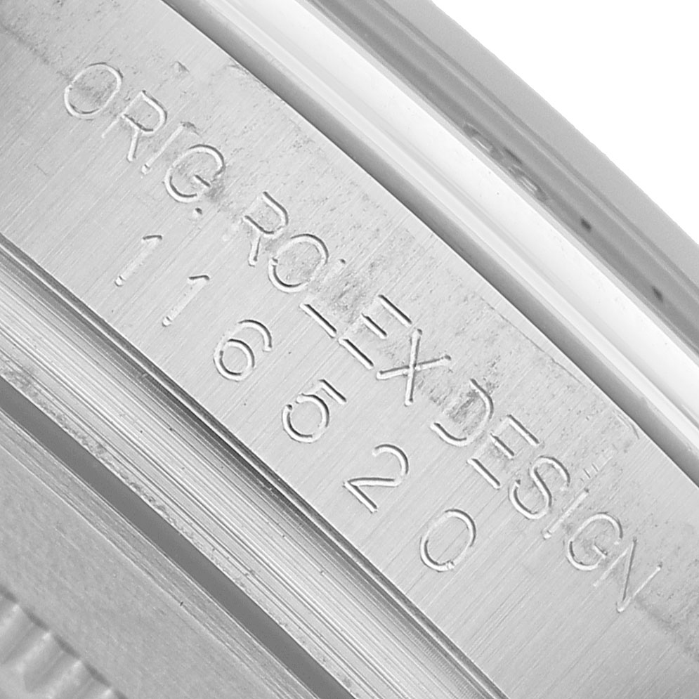 The image shows the engraved serial number on the side of the case of a Rolex Daytona 116520 Men's Stainless Steel Black Dial watch.