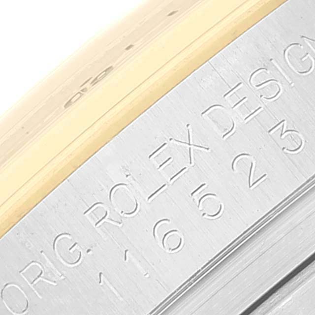 The image shows a close-up angle of the casing edge with engravings of the Rolex Daytona 116523 Men
s Steel and Gold (two tone) White Dial 116523 Men
s Steel and Gold (two tone) White Dial watch.