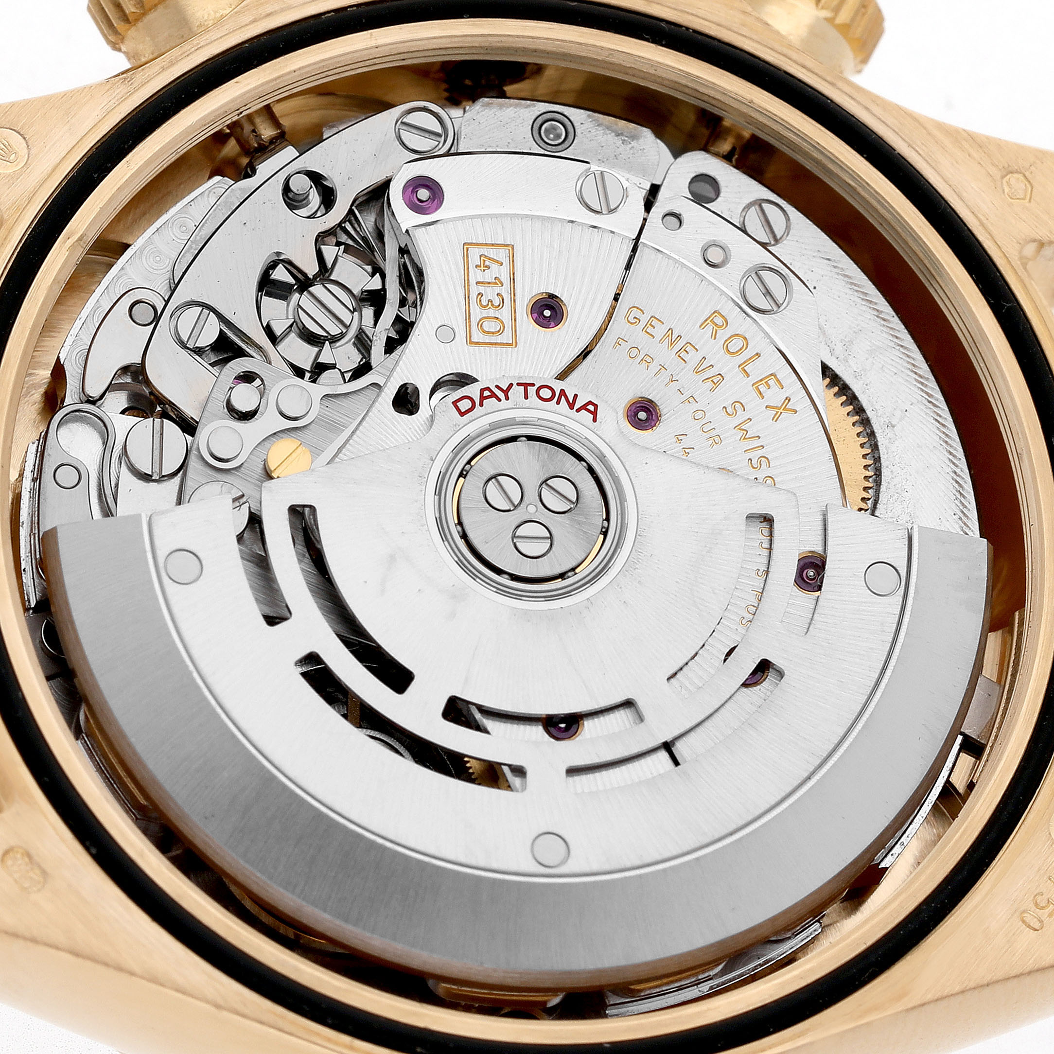 The image shows the movement mechanism of a Rolex Daytona 116528 Men's Yellow Gold Mother of Pearl Dial watch from a back angle, highlighting its intricate components.