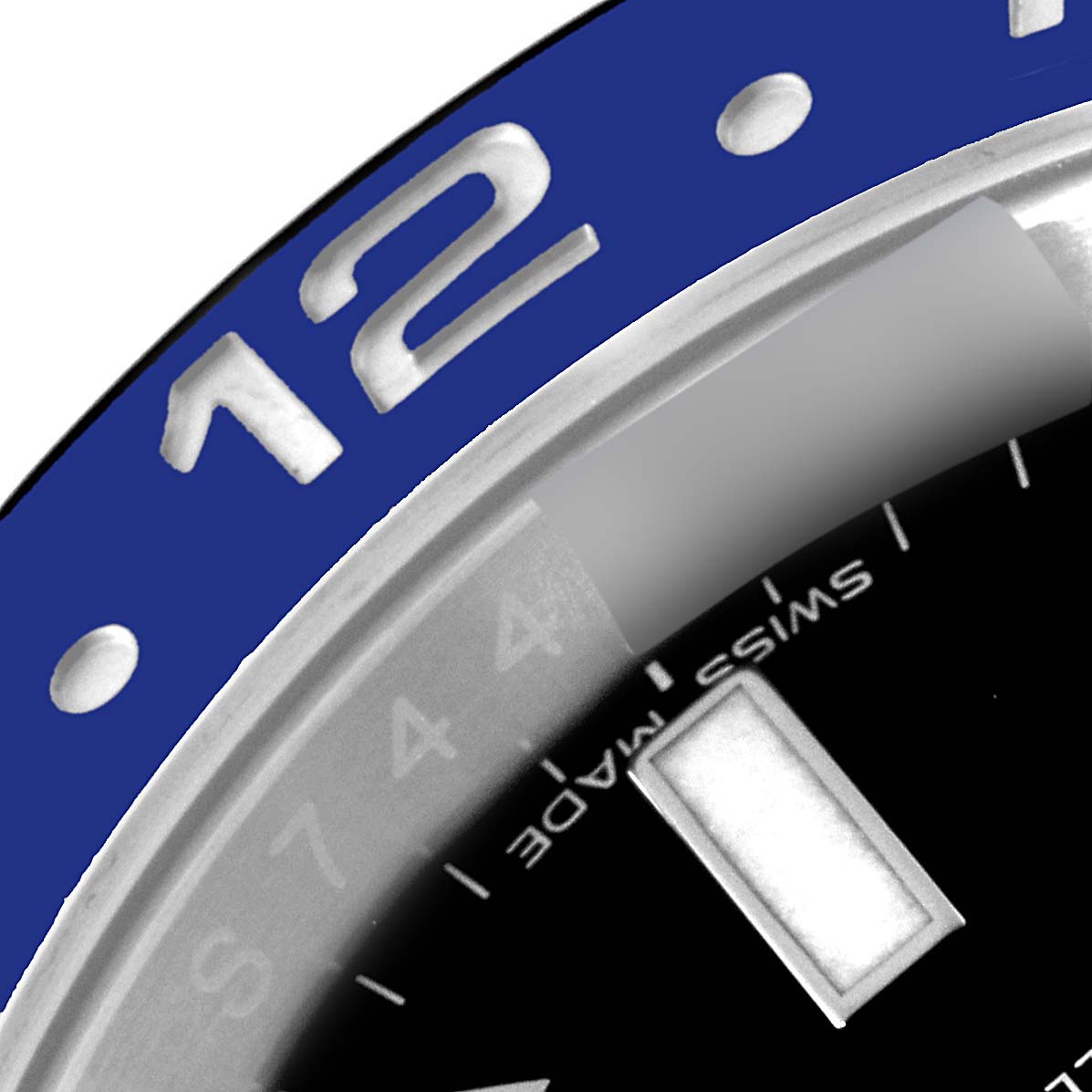 This close-up image of the Rolex GMT-Master 116710 Men
s Stainless Steel Black Dial 116710 Men
s Stainless Steel Black Dial watch shows a part of the bezel, the number 12, and a part of the dial with markers.