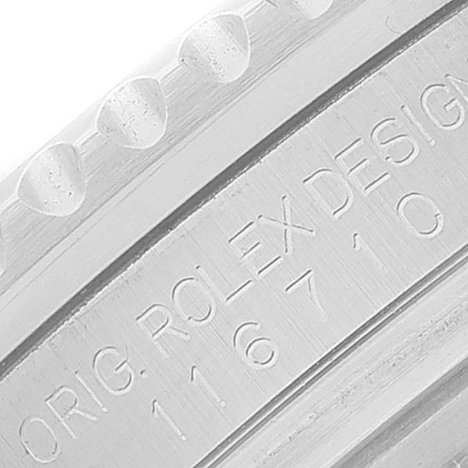 The image shows a close-up of the engraved bezel and part of the case of a Rolex GMT-Master 116710 Men
s Stainless Steel Black Dial 116710 Men
s Stainless Steel Black Dial watch.