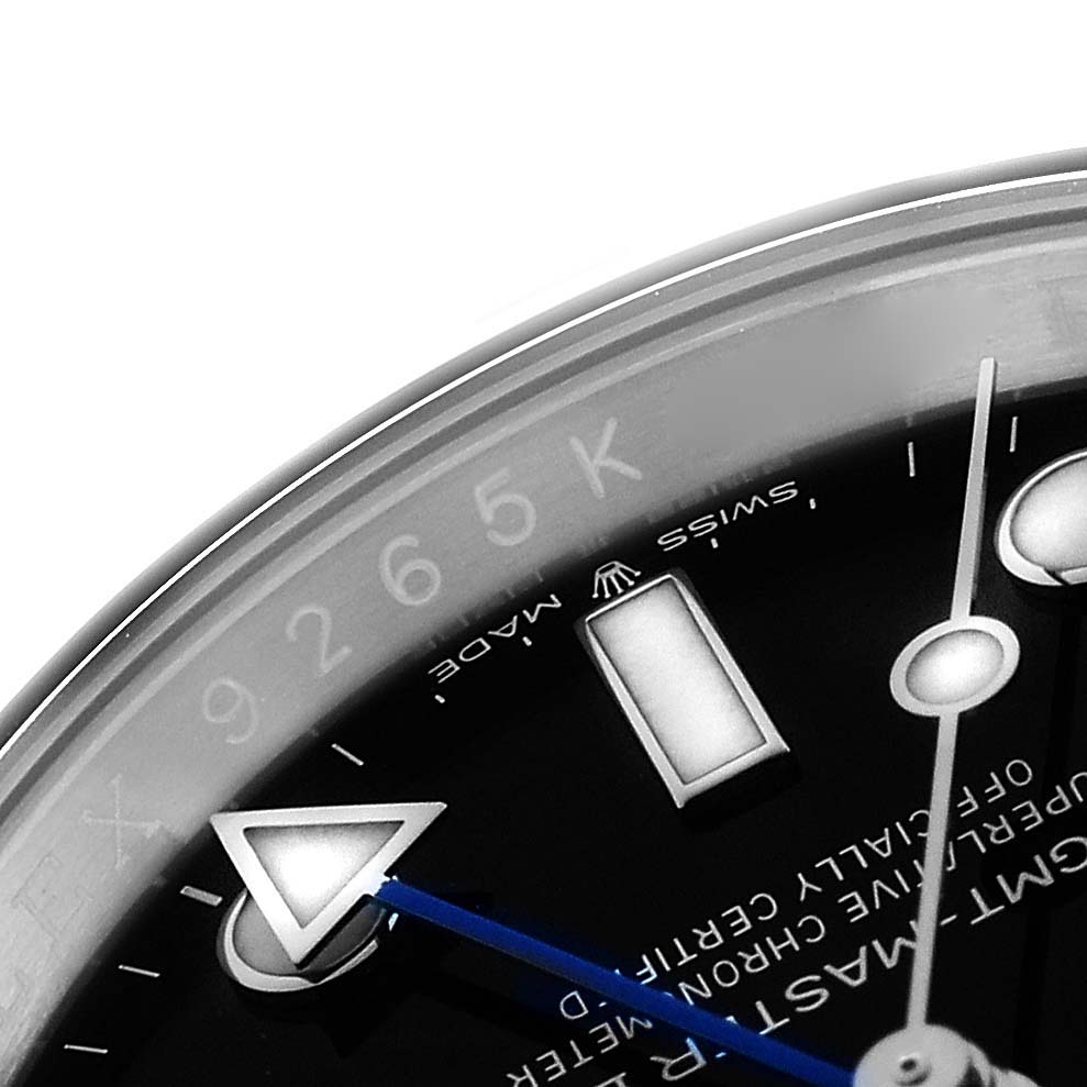 The image shows a close-up of the Rolex GMT-Master 126710 Men
s Stainless Steel Black Dial watch face, focusing on the hour markers, hands, and partial bezel.