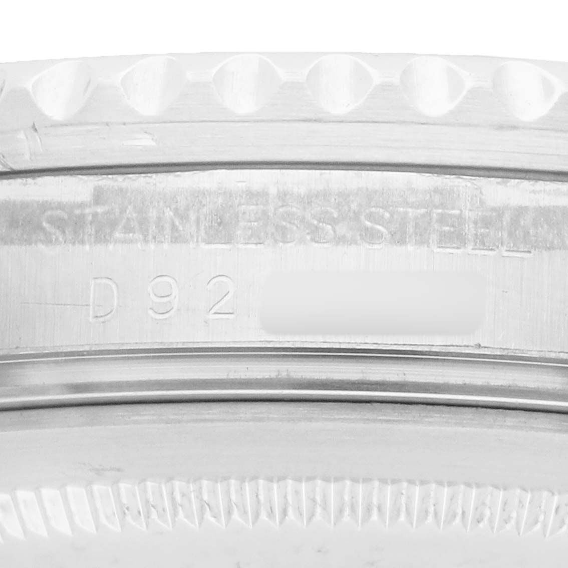 The image shows a close-up of the Rolex GMT-Master 16710 Men
s Stainless Steel Black Dial
s stainless steel case back, highlighting the engraved serial number.