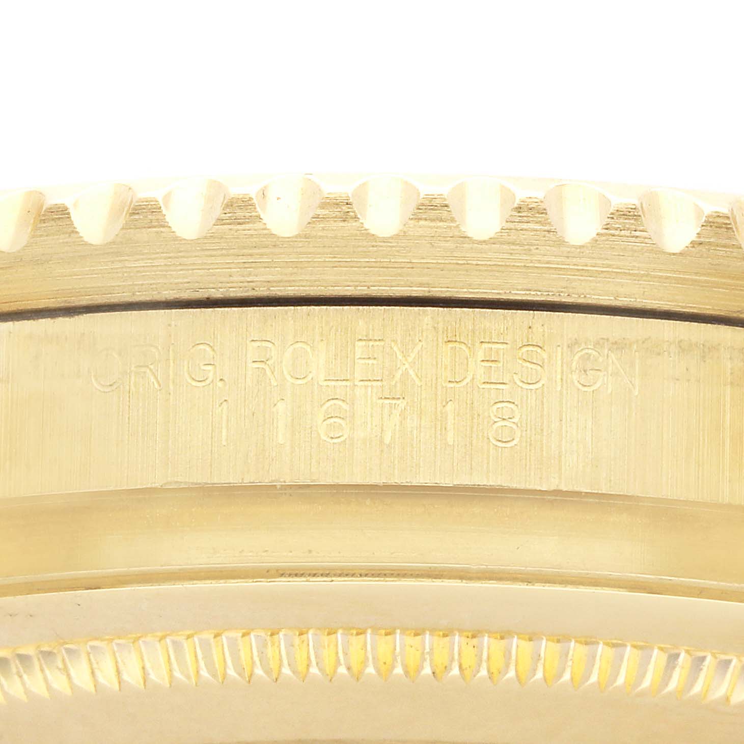 The image shows the side view of a Rolex GMT-Master 116718 Men's Yellow Gold Green Dial's gold bezel and case with engraved serial numbers.