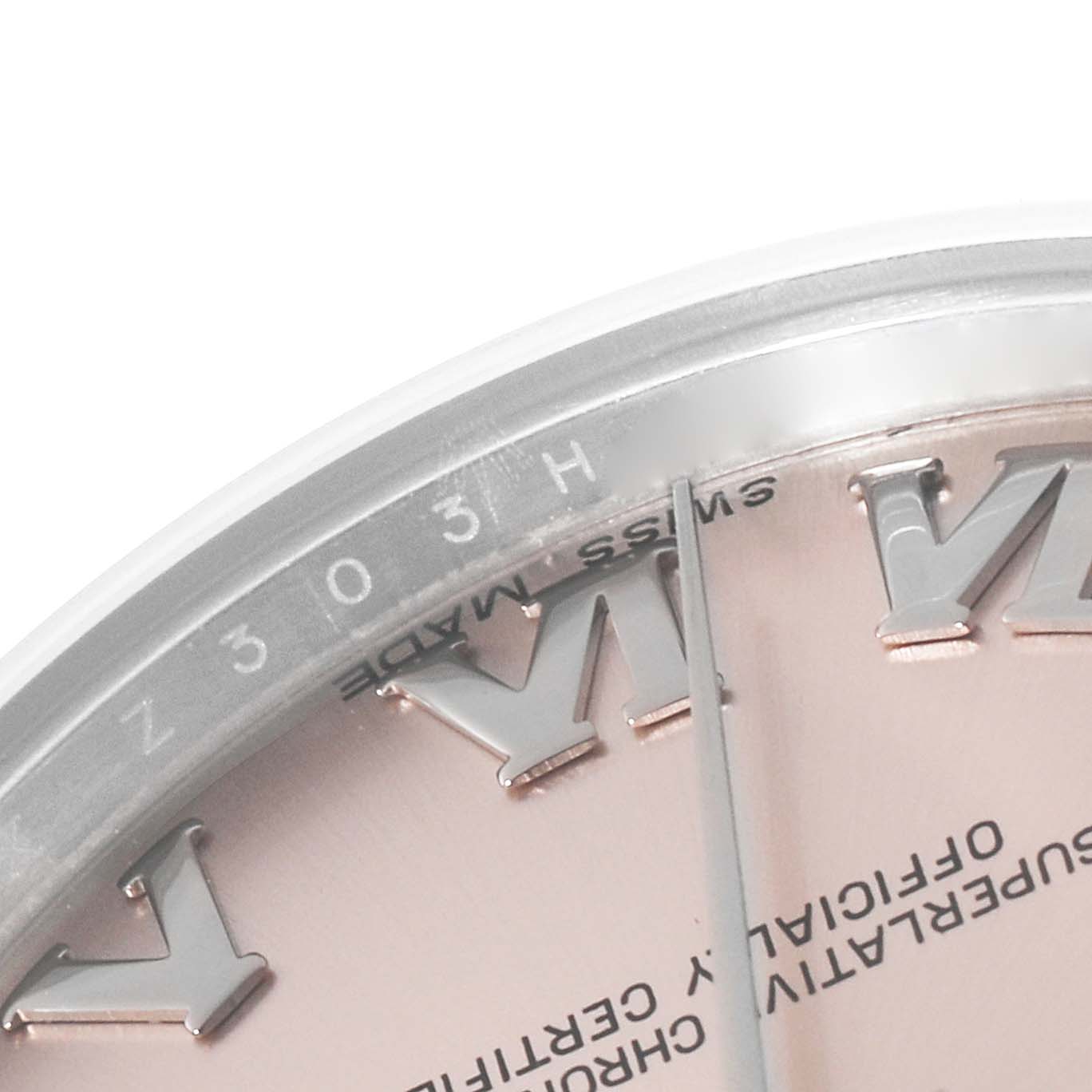 This image shows a close-up of the bezel and partial dial of a mid-size Rolex watch, displaying Roman numerals and "Swiss Made" text.