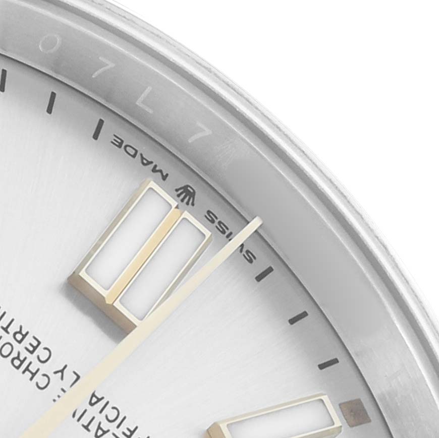 The image shows a close-up angle of the Rolex Oyster Perpetual 124300 Men
s Stainless Steel Silver Dial
s dial, highlighting the hour markers and "Swiss Made" text.