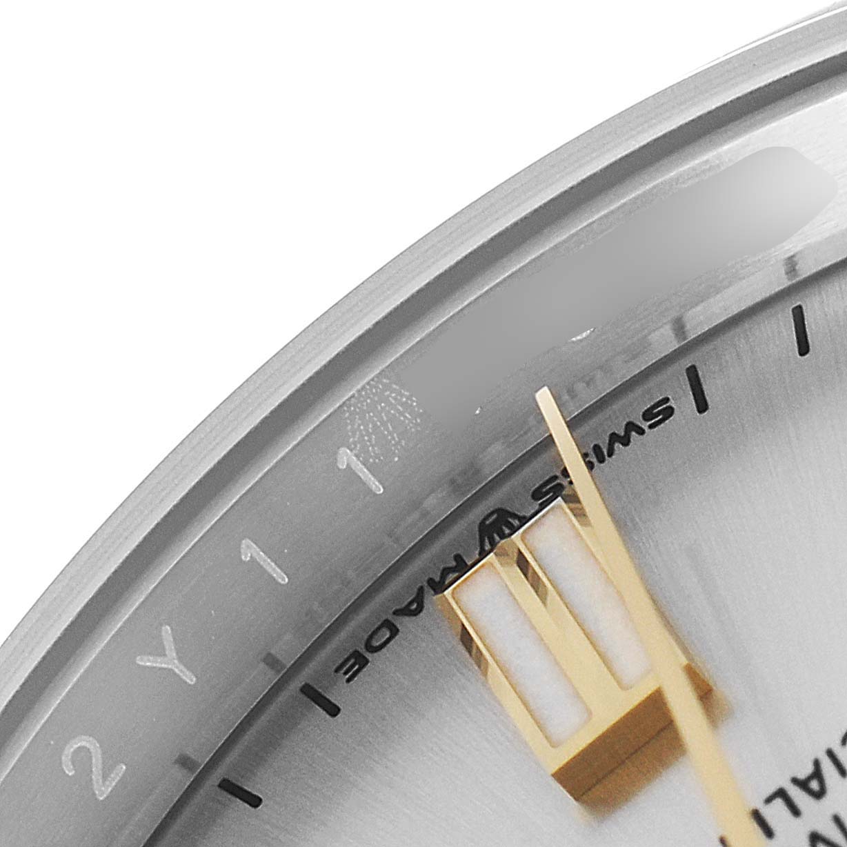 This close-up image shows part of the dial and the minute hand of a Rolex Oyster Perpetual 126000 Men's Stainless Steel Silver Dial 126000 Men's Stainless Steel Silver Dial watch.