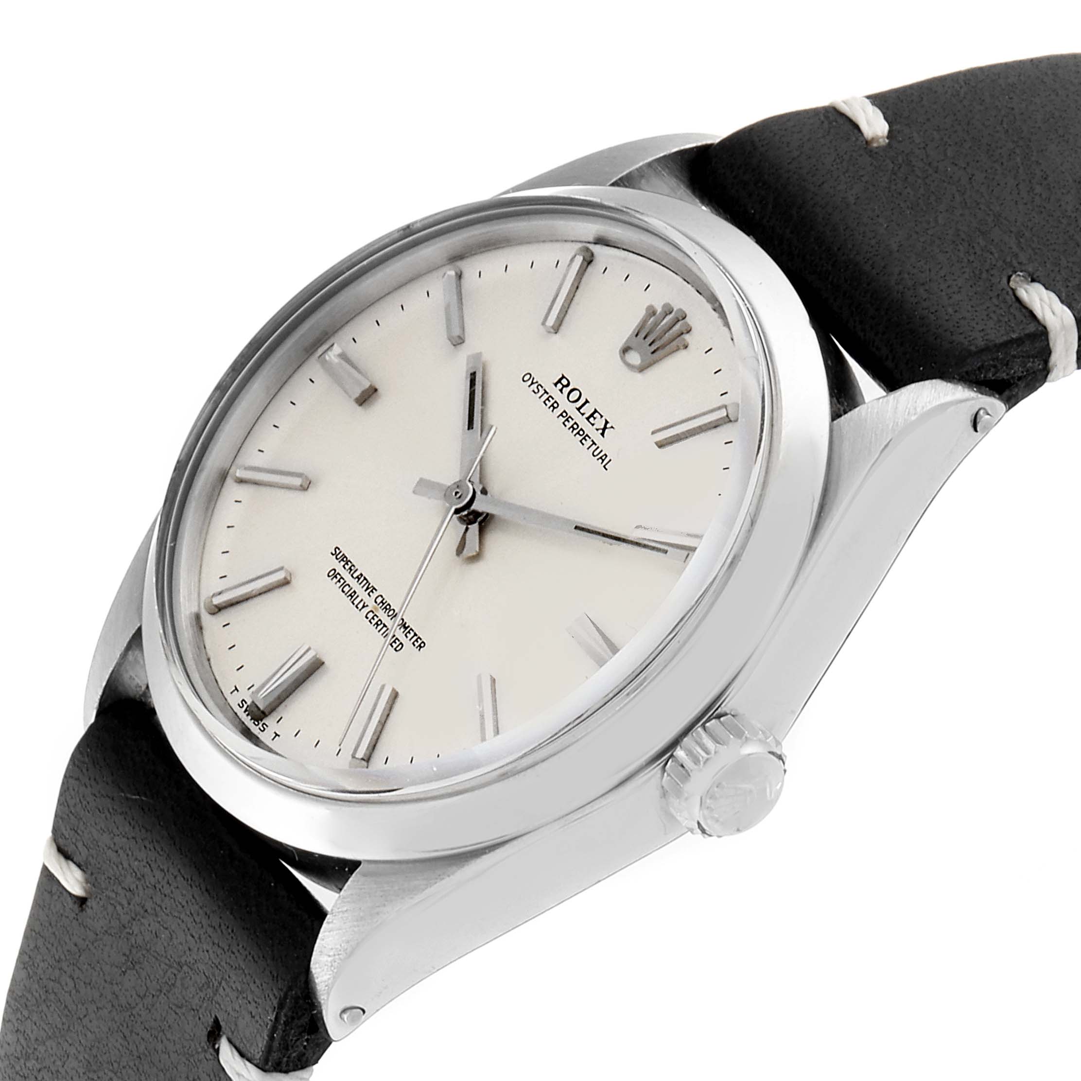 This image shows a side and partial top view of a Rolex Oyster Perpetual 1002 Men's Stainless Steel Silver Dial 1002 Men's Stainless Steel Silver Dial, highlighting the case, crown, dial, and part of the leather strap.