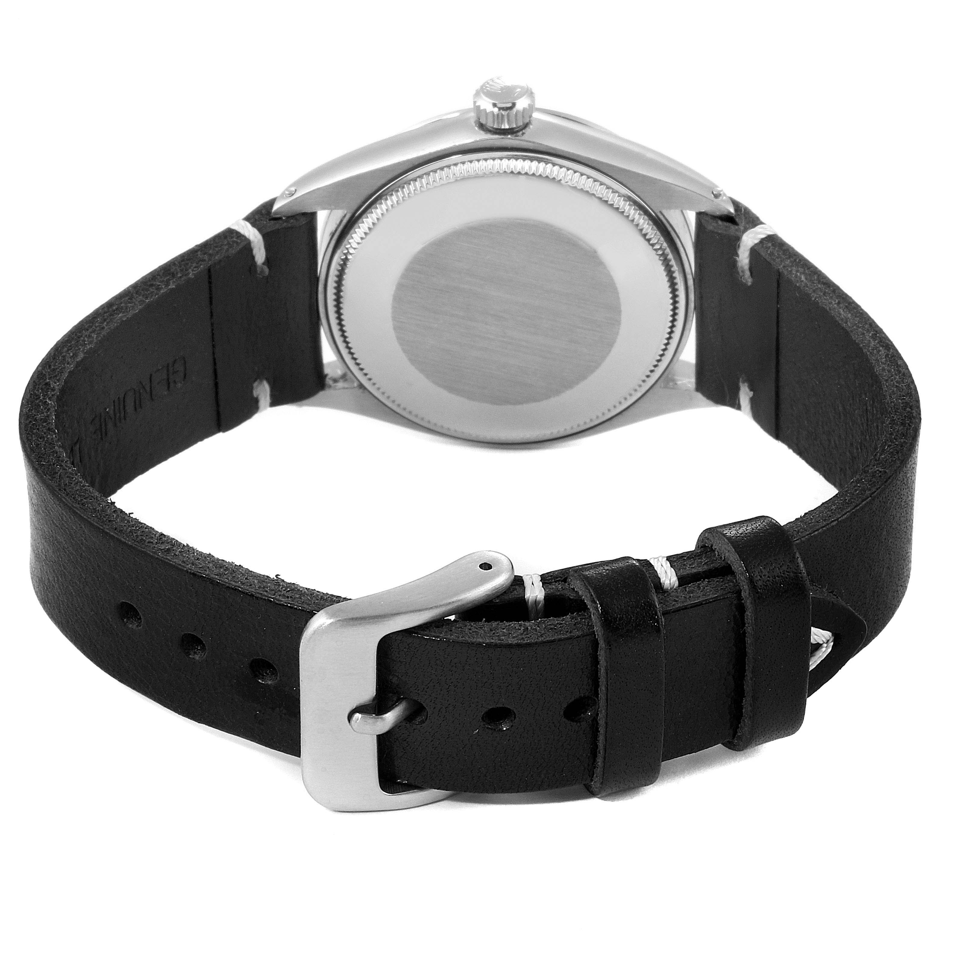 The image shows the back casing and black leather strap of a Rolex Oyster Perpetual 1002 Men's Stainless Steel Silver Dial 1002 Men's Stainless Steel Silver Dial watch.