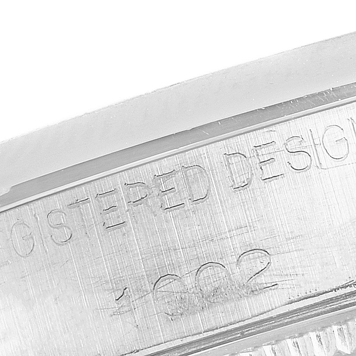The image shows a close-up of the engraved inner bezel of a Rolex Oyster Perpetual 1002 Men's Stainless Steel Silver Dial 1002 Men's Stainless Steel Silver Dial watch.