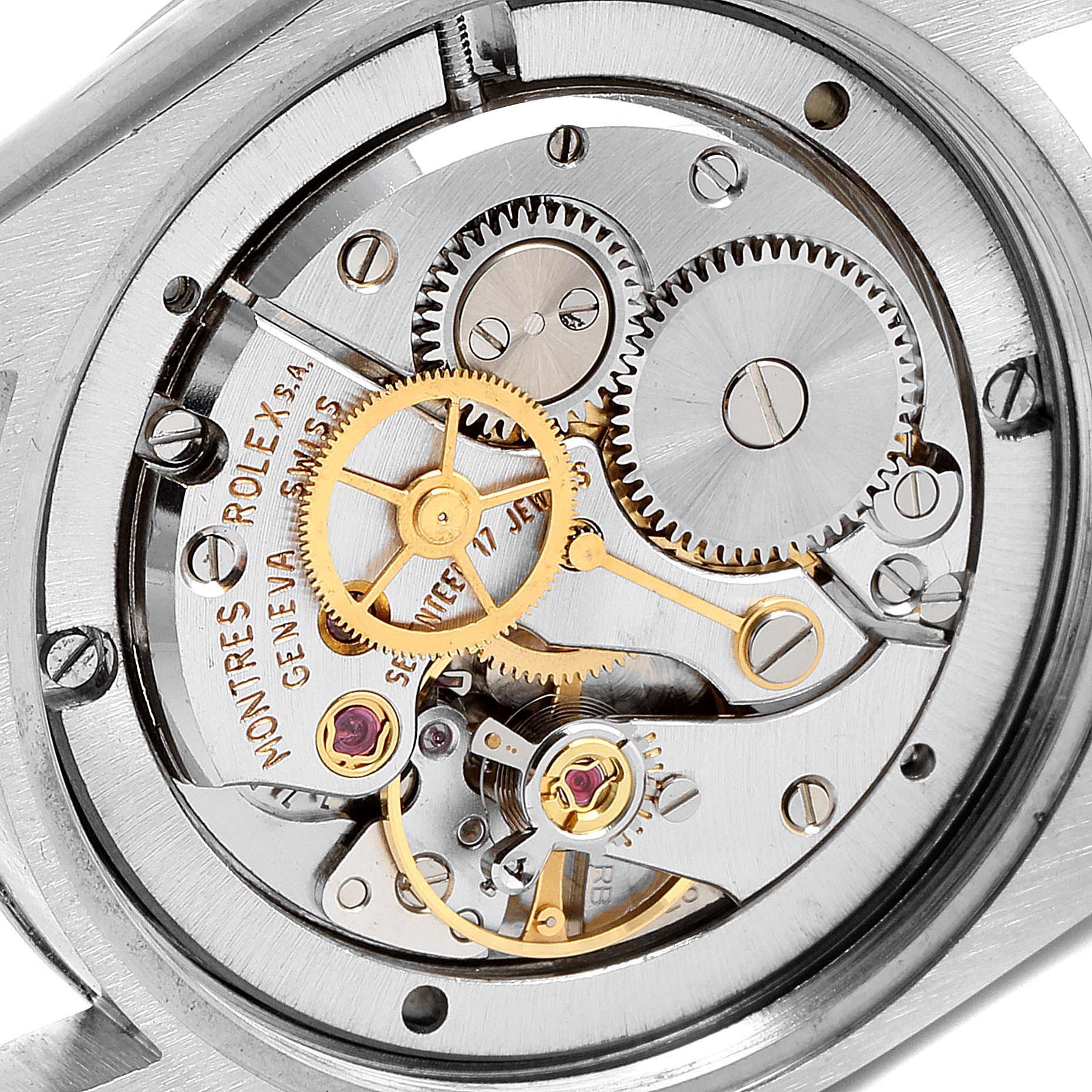 The image shows the internal mechanical movement of a Vintage Collection Rolex watch from the back angle, highlighting gears and jewels.