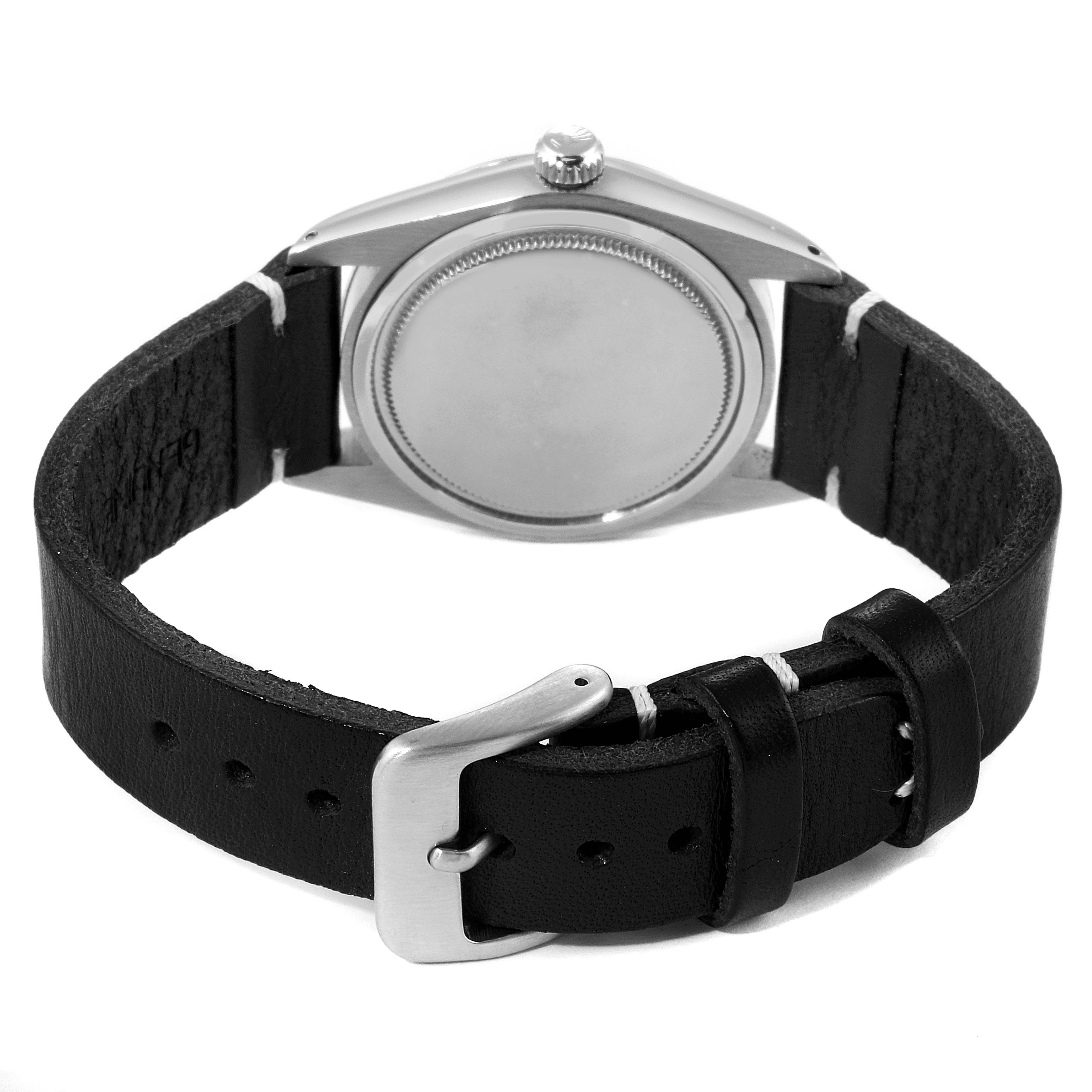 The image shows the back view of the Vintage Collection model by Rolex, highlighting the case back and leather strap with buckle.