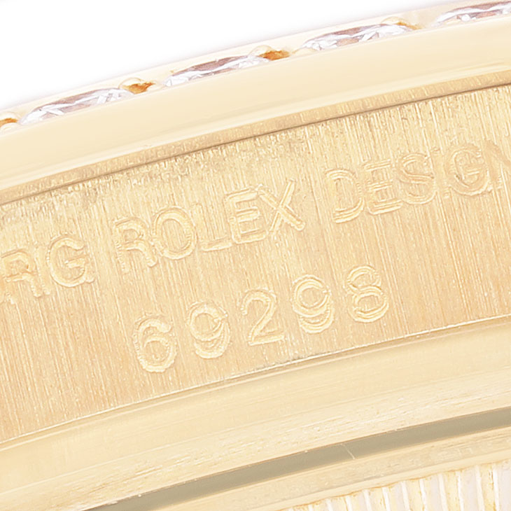 The image shows a close-up of the engraved side of a Rolex Pearlmaster 69298 Women's Yellow Gold Mother of Pearl Dial watch case, displaying its reference number.