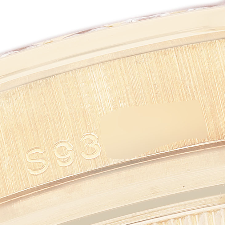 The image shows a close-up of the Rolex Pearlmaster 69298 Women's Yellow Gold Mother of Pearl Dial's gold bezel with visible engravings.