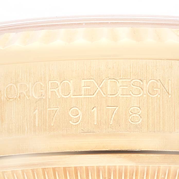 The image shows a close-up of the model number and "Rolex Design" engraving on the President model watch by Rolex.