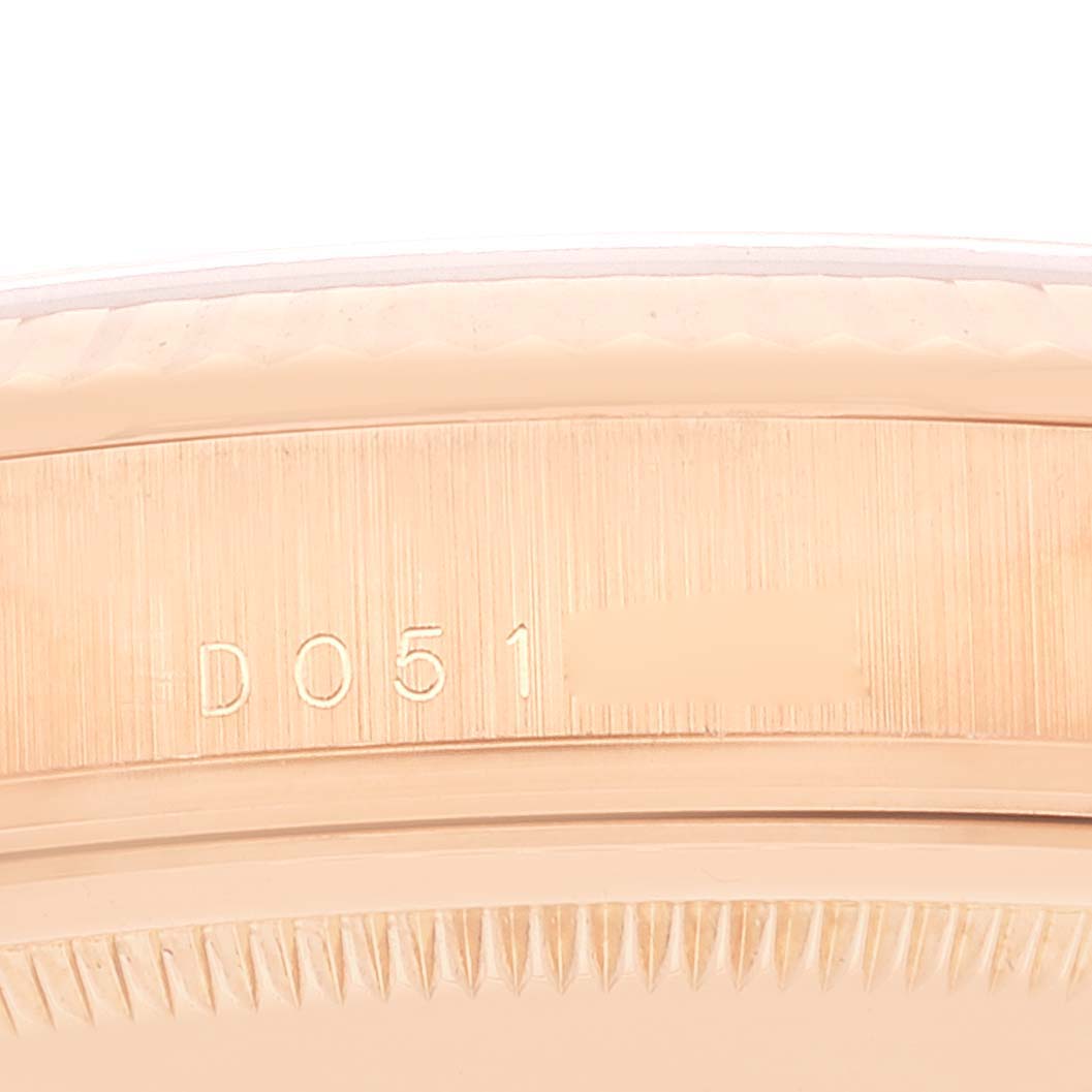 The image shows a close-up of the side engraved with a serial number of the Rolex President 118235 Men's Rose Gold Black Dial 118235 Men's Rose Gold Black Dial model watch.