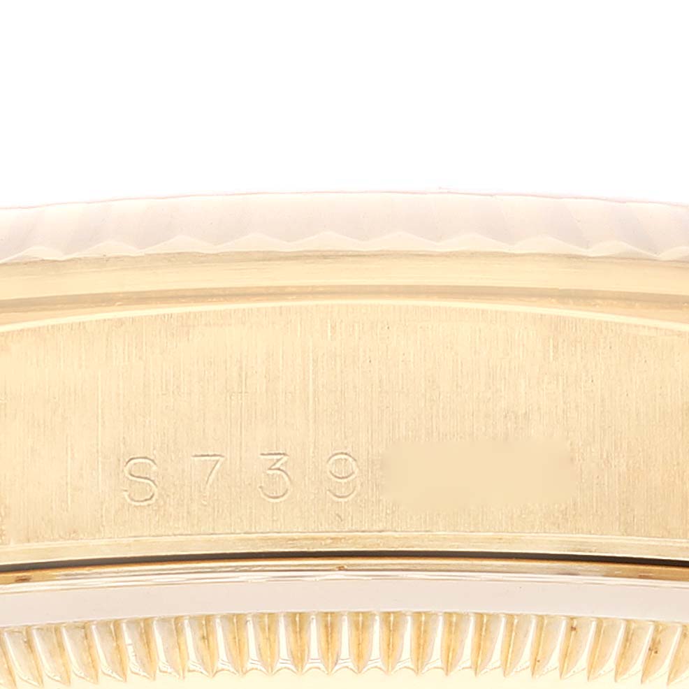 This image shows a close-up of the serial number engraving on the side of the case of a Rolex President 18238 Men's Yellow Gold Champagne Dial 18238 Men's Yellow Gold Champagne Dial model watch.