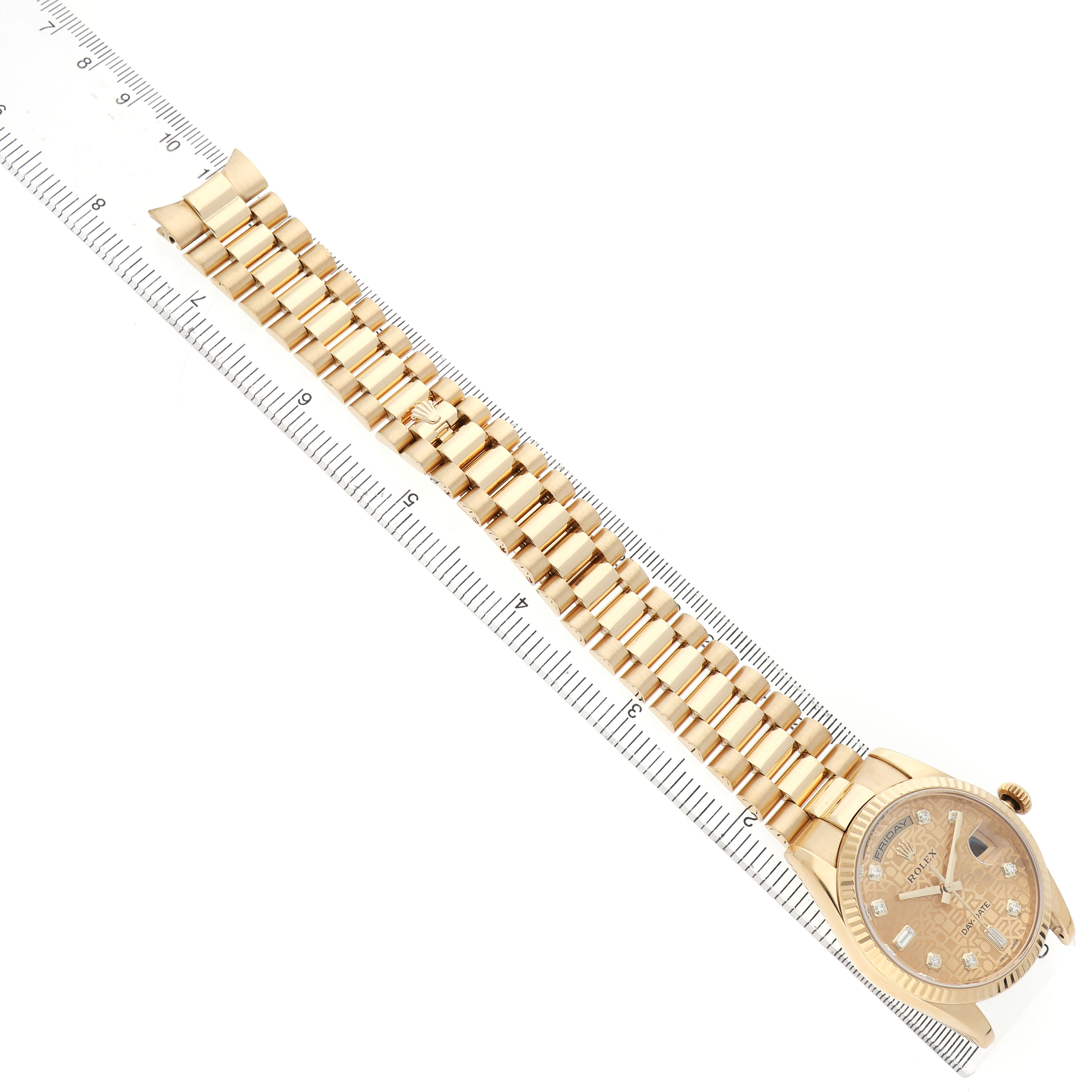 The watch, a Rolex President 118238 Men's Yellow Gold Champagne Dial model, is shown diagonally, featuring the gold band and dial with a ruler for scale.