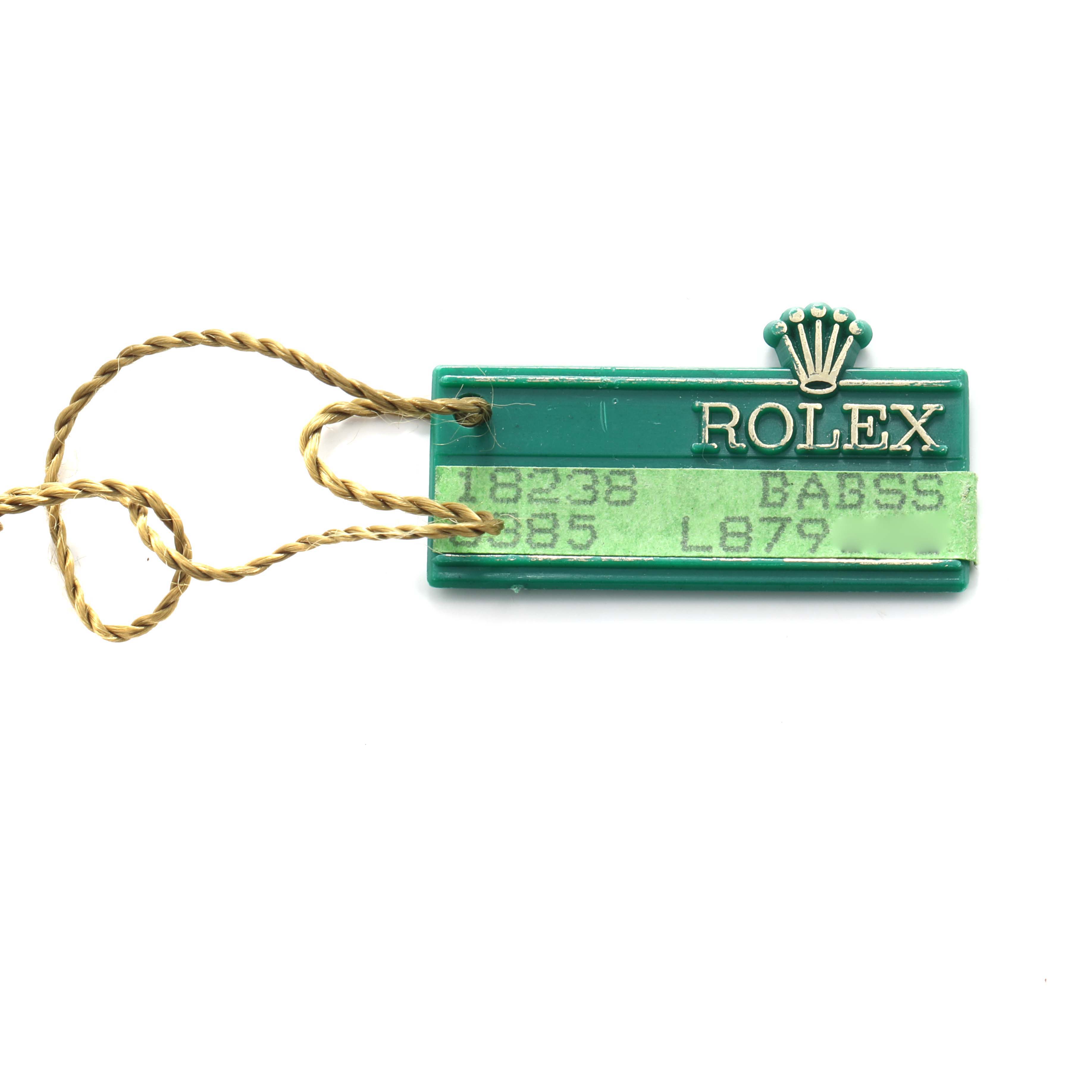 The image shows a green Rolex tag with a gold string, associated with the President model.