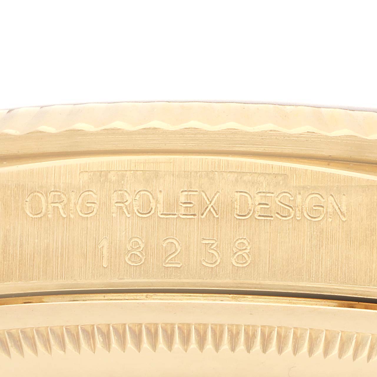The image shows a close-up of the case side of a Rolex President 18238 Men
s Yellow Gold Champagne Dial watch, highlighting the model number engraving.