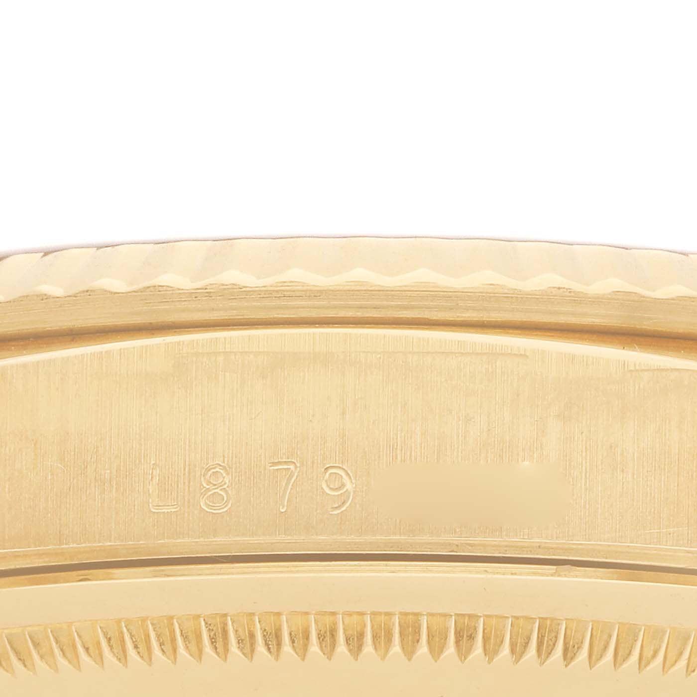 The image shows a close-up of the edge and case back of the Rolex President 18238 Men
s Yellow Gold Champagne Dial watch, highlighting its textured and engraved parts.
