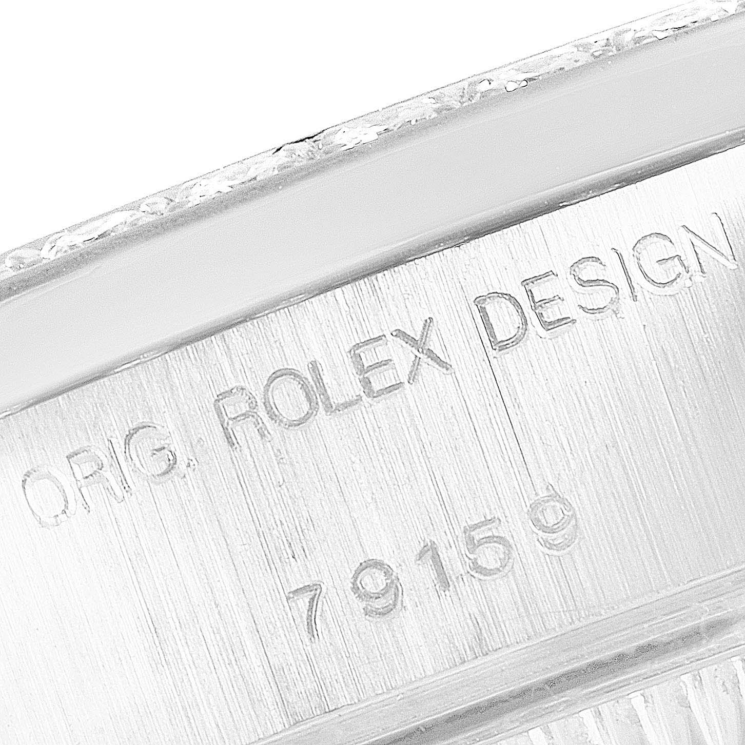 The image shows a close-up angle of the Rolex President 79159 Women
s White Gold Champagne Dial 79159 Women
s White Gold Champagne Dial model
s case, displaying the engraved text "ORIG. ROLEX DESIGN 79159".