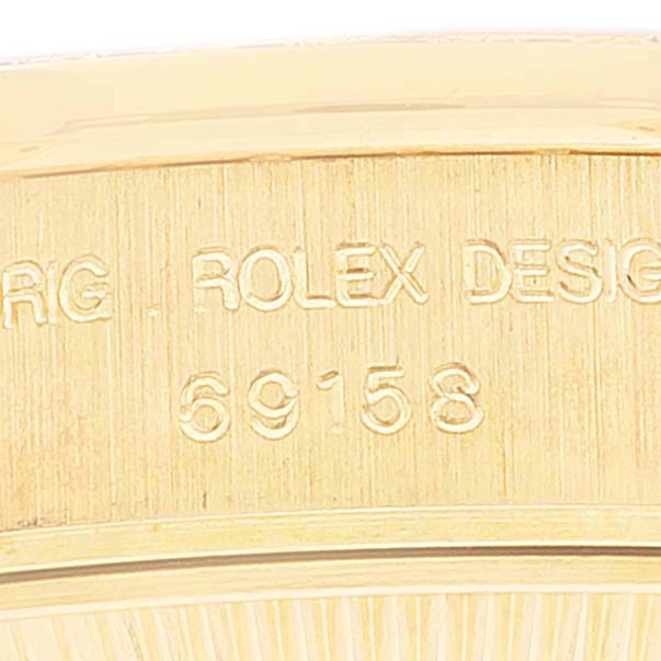 This close-up shot shows the engraved model number "69158" on the gold case side of a Rolex President 69158 Women's Yellow Gold Mother of Pearl Dial 69158 Women's Yellow Gold Mother of Pearl Dial watch.