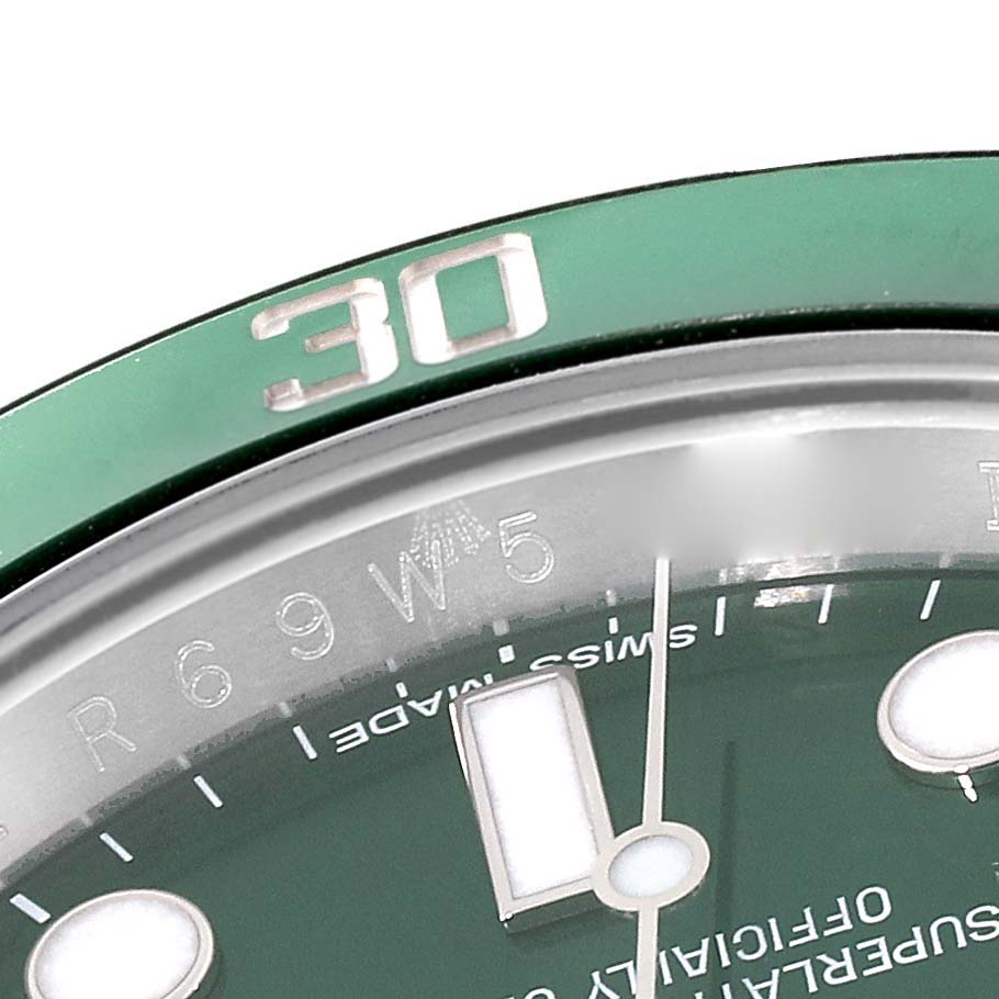 The image shows a close-up of the dial and bezel of a Rolex Submariner 116610LV Men
s Stainless Steel Green Dial 116610LV Men
s Stainless Steel Green Dial watch, highlighting the 30-minute mark on the green bezel.