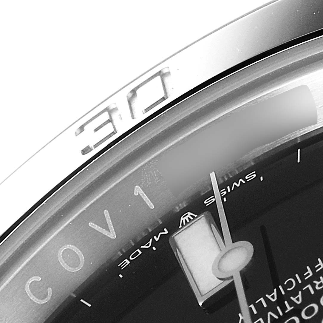 This close-up image of the Rolex Submariner 124060 Men
s Stainless Steel Black Dial 124060 Men
s Stainless Steel Black Dial watch shows the edge of the bezel, minute markers, and part of the dial.