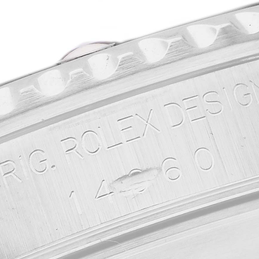 The image shows a close-up of the Rolex Submariner 14060 Men
s Stainless Steel Black Dial
s engraved case back, highlighting design details.