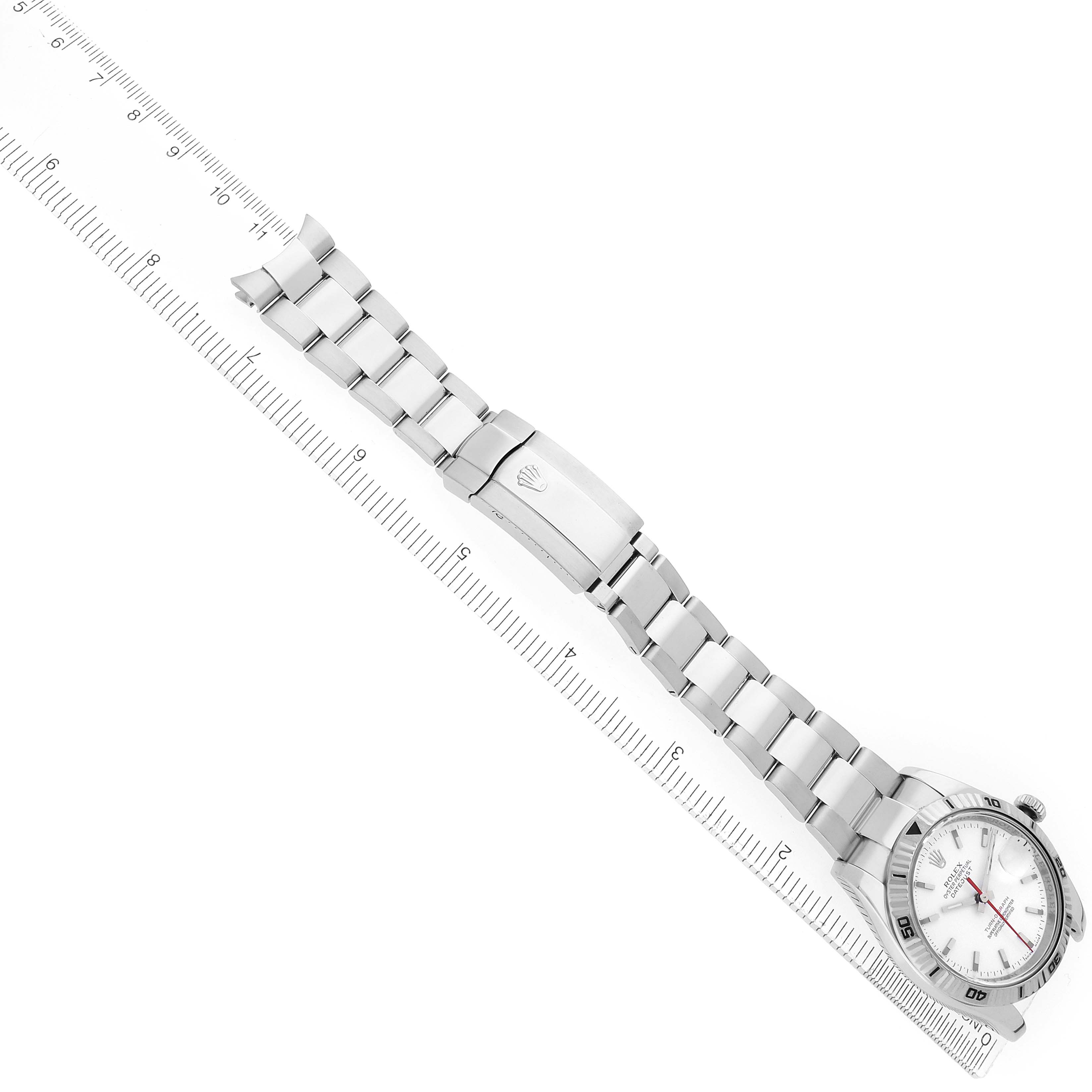 The Rolex Turn-o-Graph 116264 Men
s Stainless Steel White Dial watch is shown diagonally with its bracelet fully extended alongside a ruler for scale.