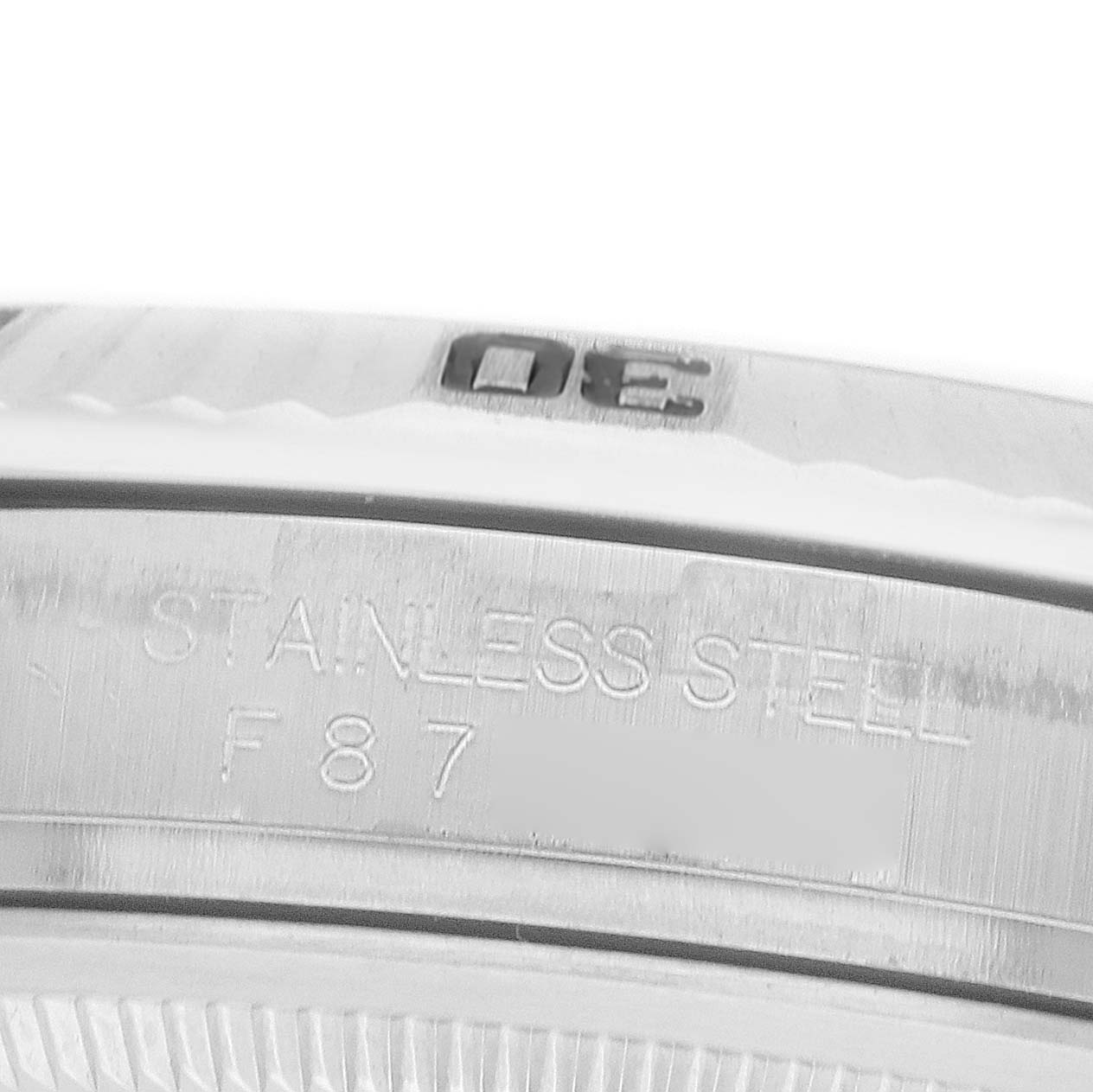 The image shows a close-up of the stainless steel bezel on a Rolex Turn-o-Graph 116264 Men
s Stainless Steel White Dial watch, highlighting the engraved markings.
