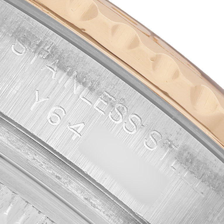 The image shows a close-up of the Rolex Yacht-Master 169623 Women's Steel and Gold (two tone) Blue Dial's engraved case side and bezel edge in a gold hue.