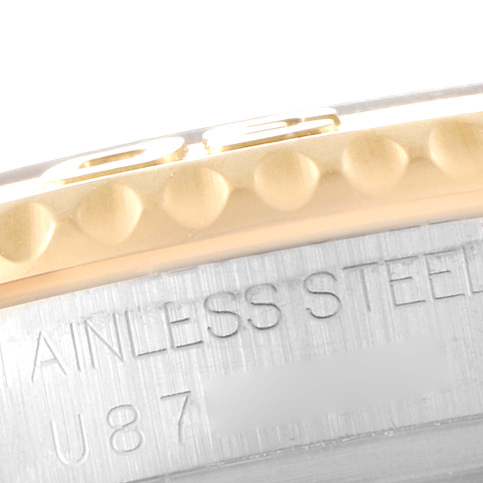 Close-up angle of a Rolex Yacht-Master 68623 Men
s Steel and Gold (two tone) Grey Dial 68623 Men
s Steel and Gold (two tone) Grey Dial showing part of the gold bezel and stainless steel case with inscriptions.