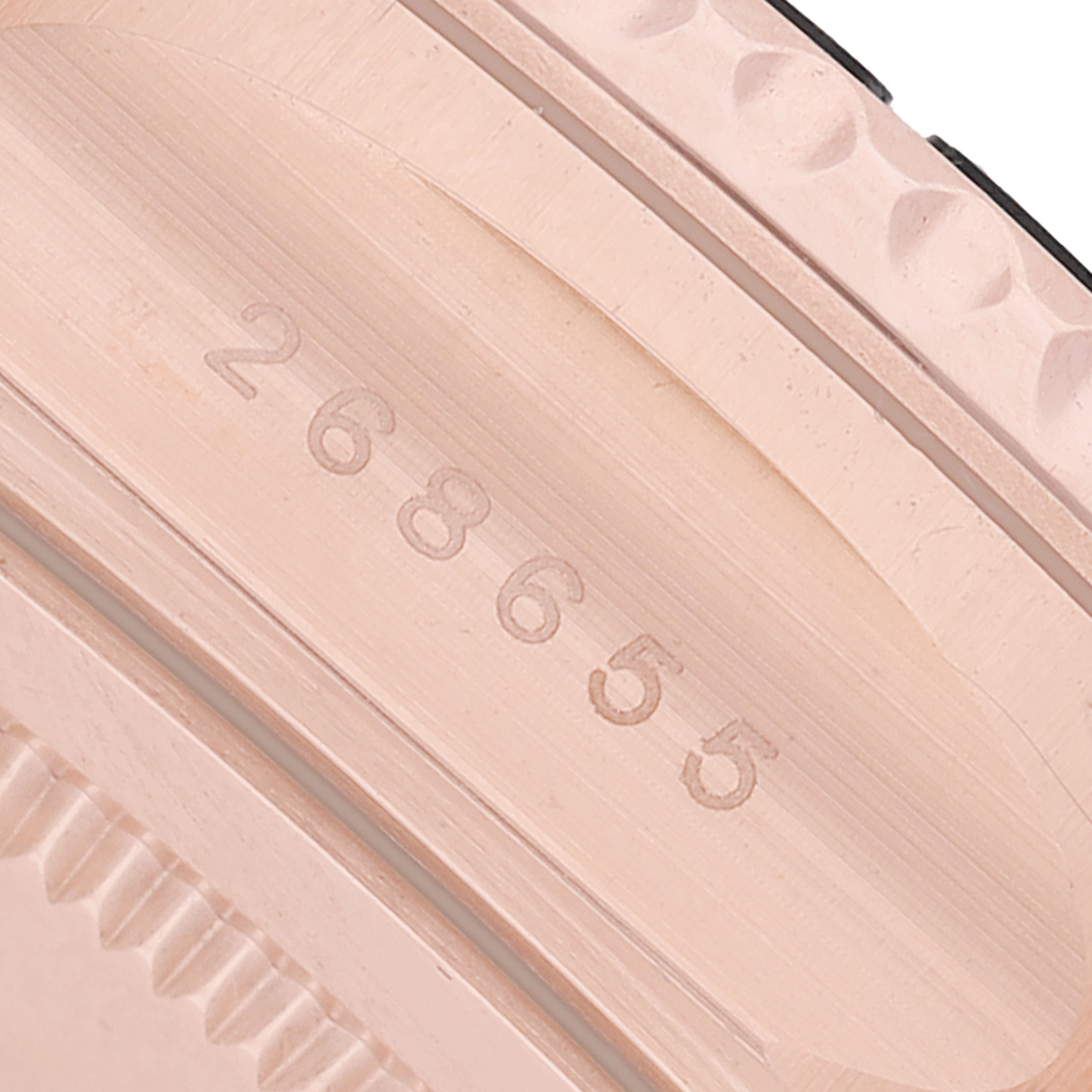 The image shows a close-up of the side bezel of a Rolex Yacht-Master 268655 Men's Rose Gold Black Dial, featuring engraved numbers.