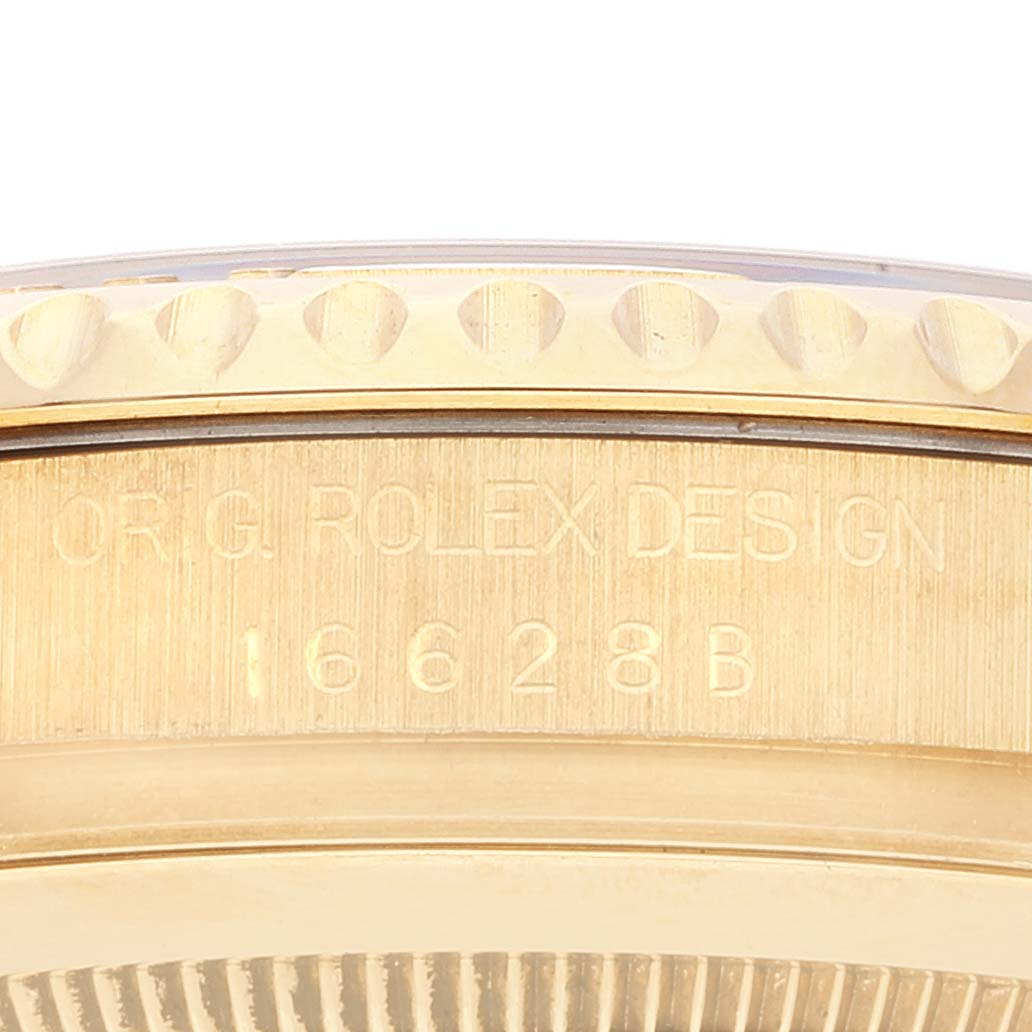The image shows a close-up of the side of a Rolex Yacht-Master 16628 Men
s Yellow Gold Blue Dial 16628 Men
s Yellow Gold Blue Dial watch with the model number 16628B engraved.