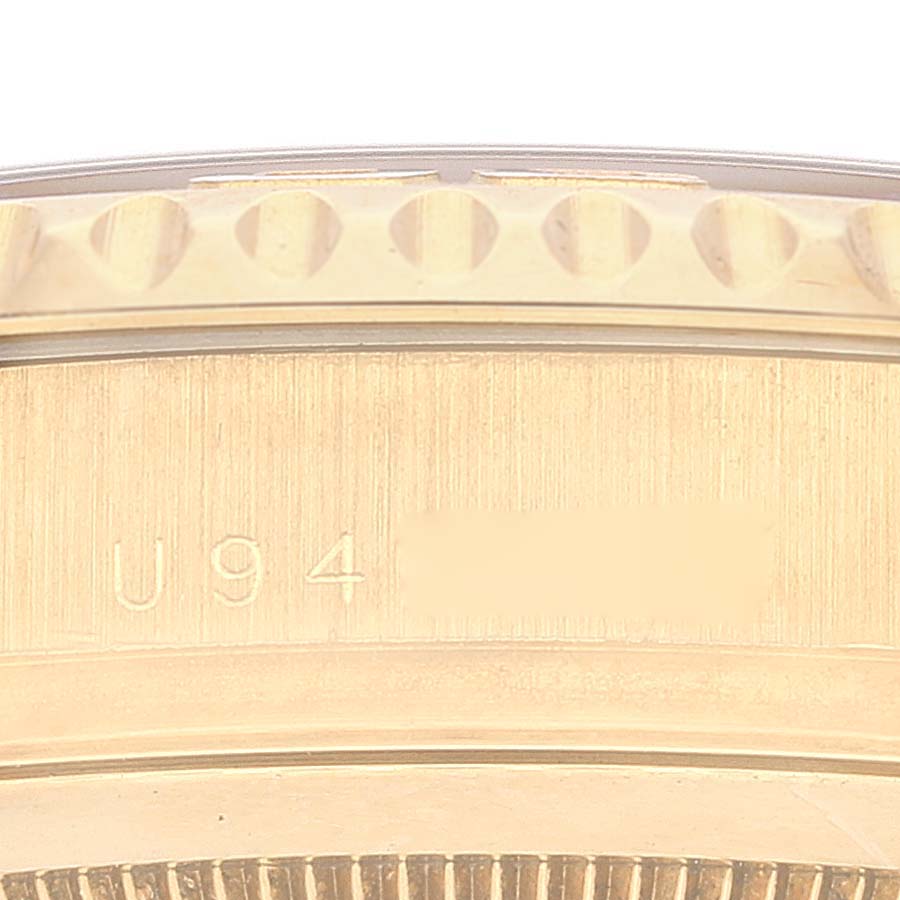 This image shows a close-up of the side of the Rolex Yacht-Master 16628 Men
s Yellow Gold Blue Dial 16628 Men
s Yellow Gold Blue Dial watch, focusing on the bezel and part of the case with an engraved serial number.
