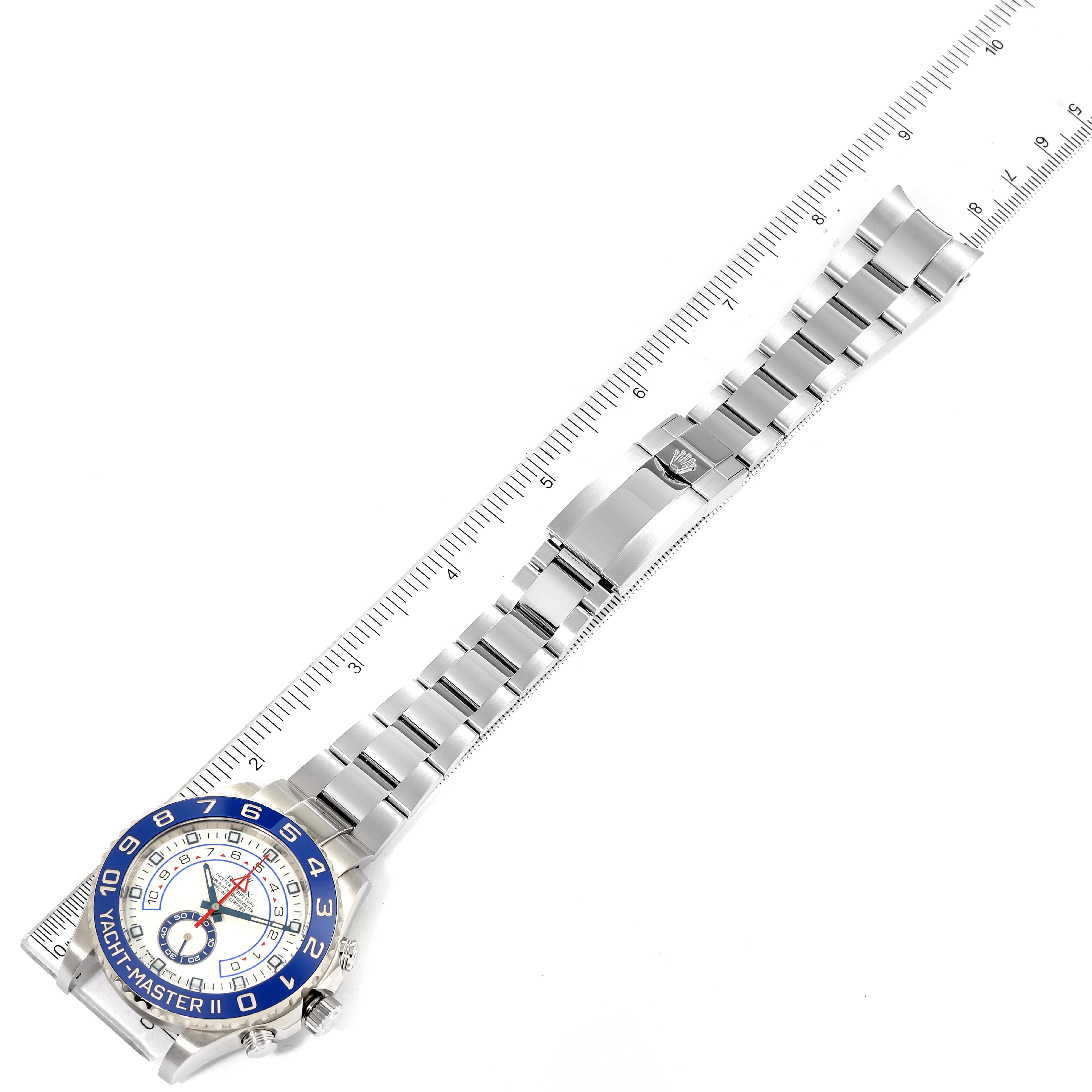 The Rolex Yacht-Master 116680 Men's Stainless Steel White Dial 116680 Men's Stainless Steel White Dial watch is shown from a top-down angle, highlighting the face, bezel, and entire bracelet alongside a ruler for scale.