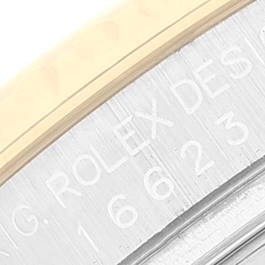 This close-up image shows the edge of the bezel and part of the engraved text on the case-back of the Rolex Yacht-Master 16623 Men
s Steel and Gold (two tone) White Dial 16623 Men
s Steel and Gold (two tone) White Dial watch.