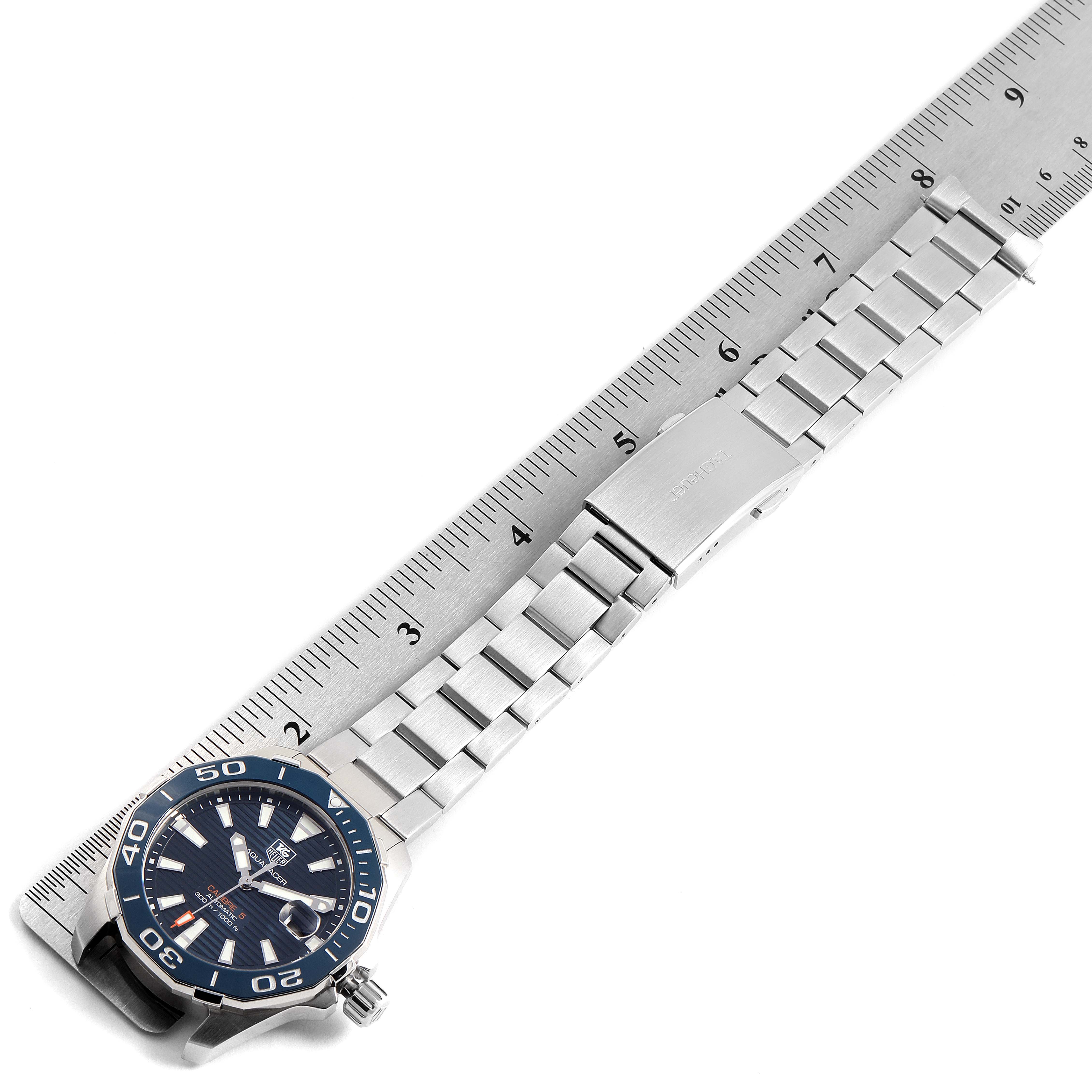 The image shows a Tag Heuer Aquaracer WAY211C.BA0928 Men
s Stainless Steel Blue Dial WAY211C.BA0928 Men
s Stainless Steel Blue Dial watch at a slight angle with a metal band next to a ruler for scale.