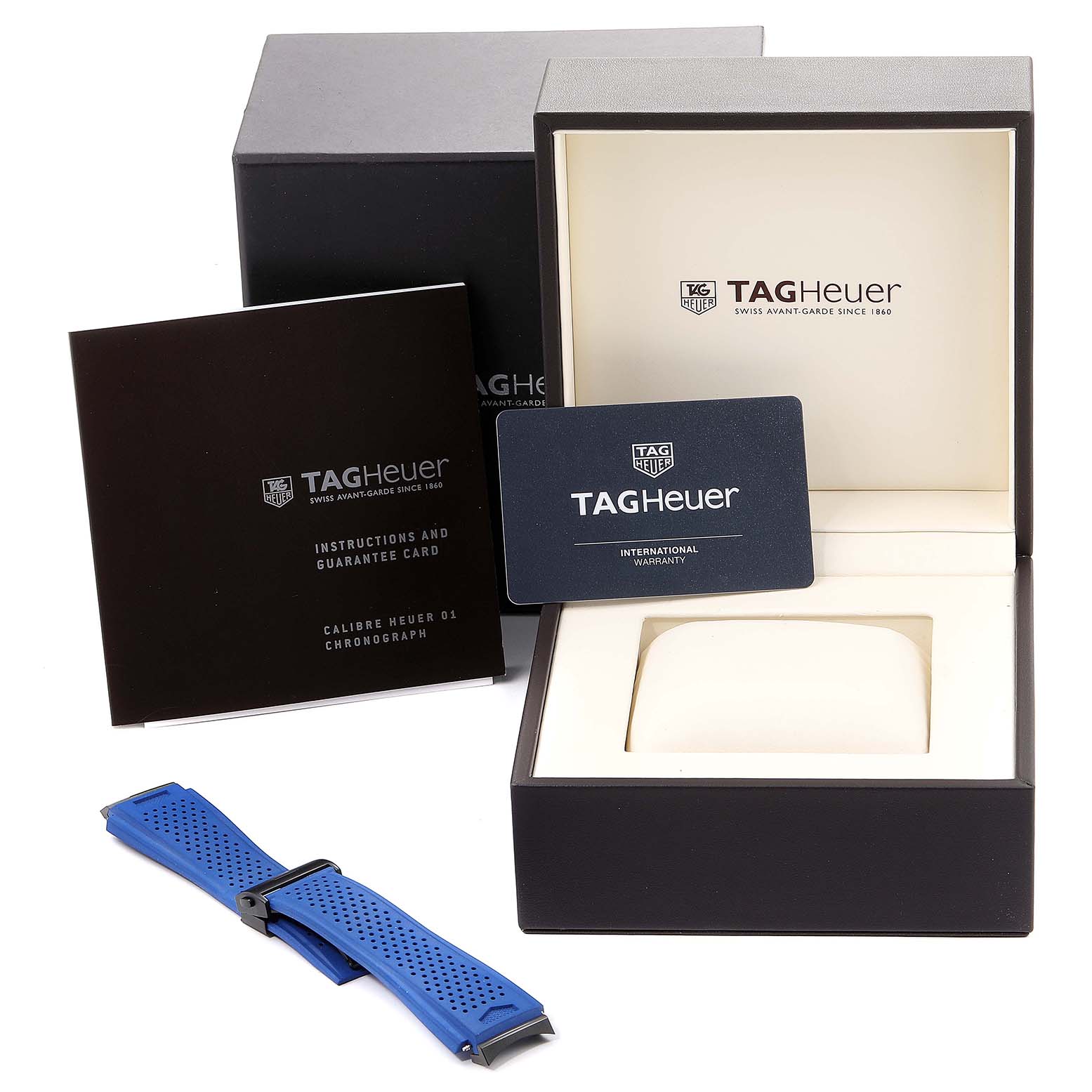 The image shows a Tag Heuer Carrera CAR2A1T Men's Titanium Black Dial CAR2A1T Men's Titanium Black Dial watch box, instruction manual, guarantee card, and a blue strap accessory.