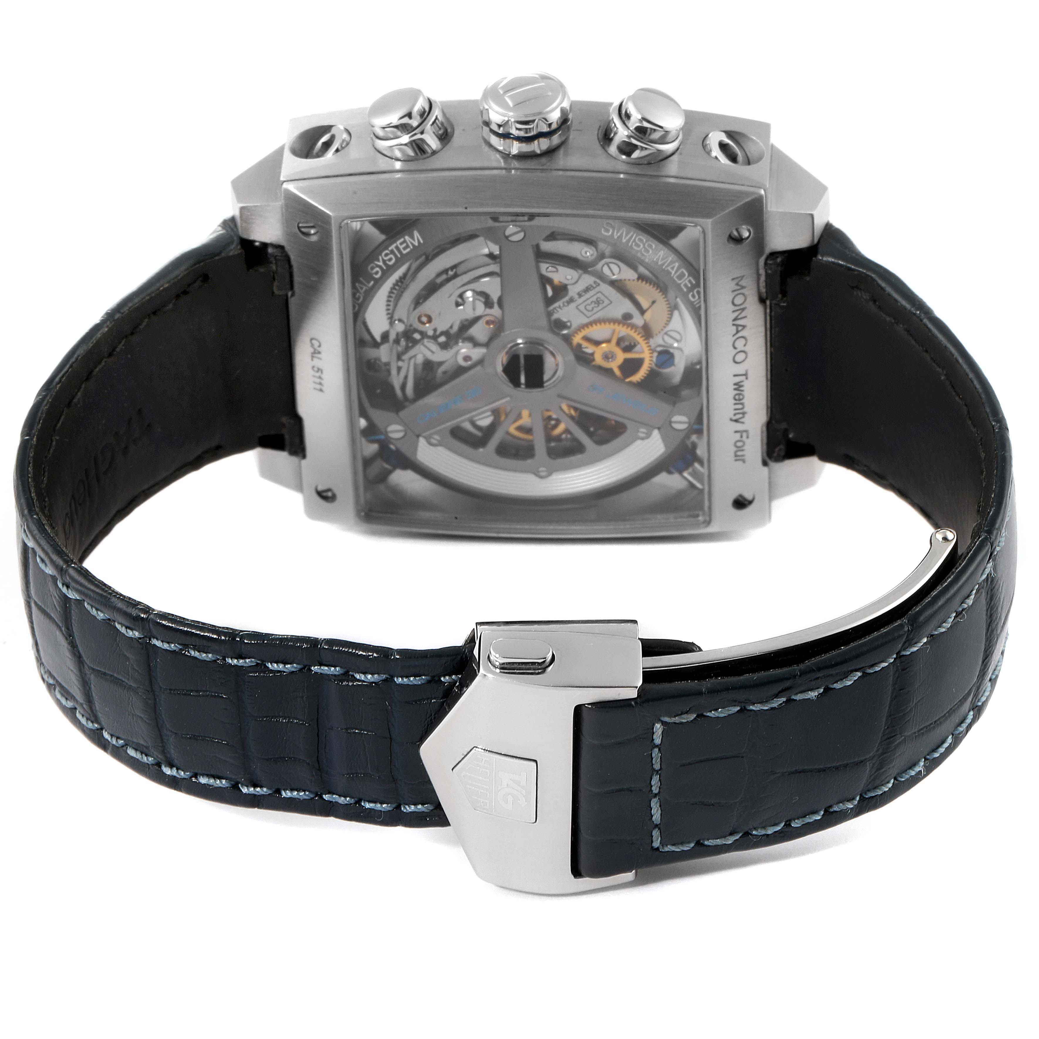 The image shows the back view of a Tag Heuer Monaco CAL5111.FC6299 Men
s Stainless Steel Blue Dial CAL5111.FC6299 Men
s Stainless Steel Blue Dial watch, displaying the movement mechanism and a leather strap with a clasp.