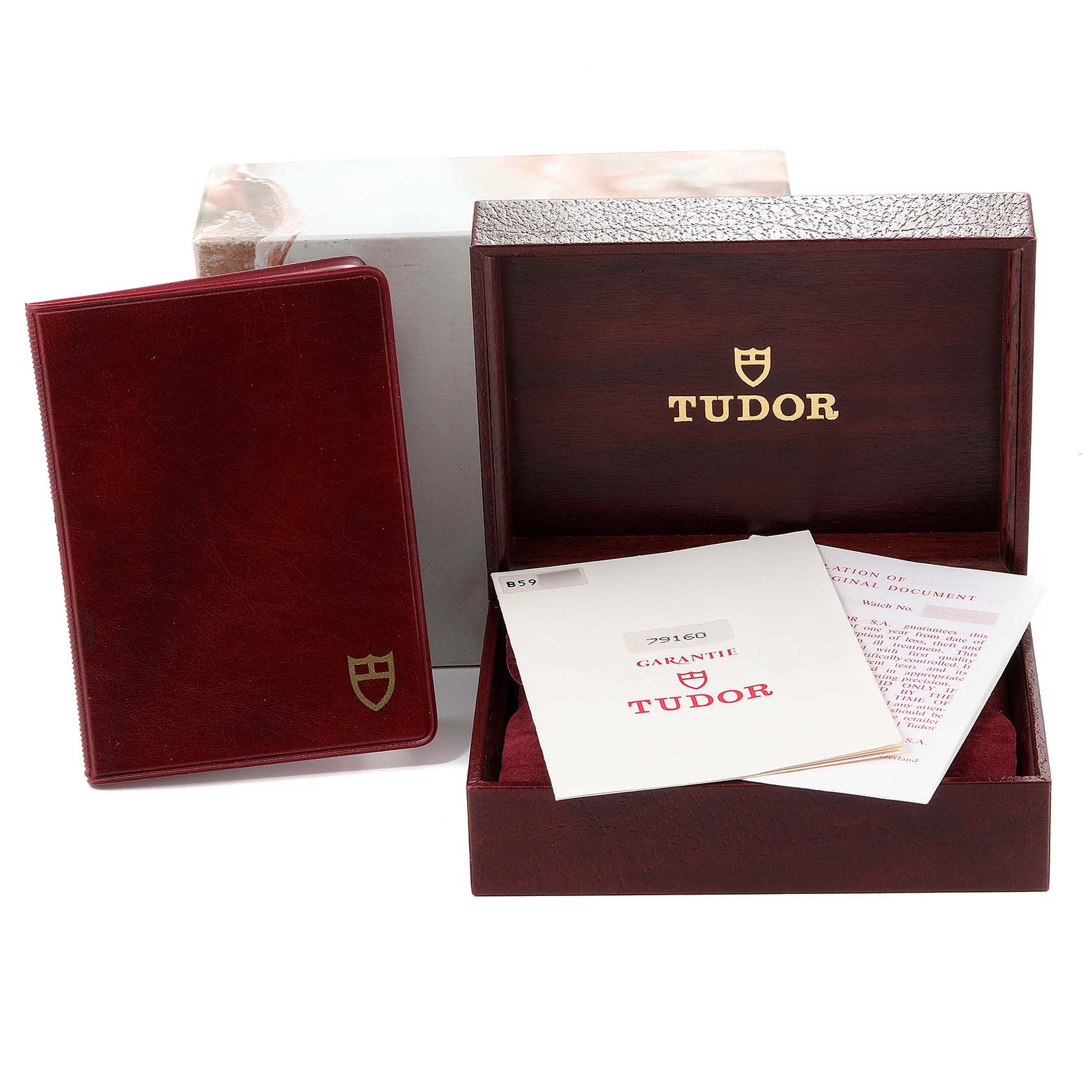 The image shows the packaging, warranty cards, and manual for the Tudor Big Block 79160 Men
s Stainless Steel Black Dial 79160 Men
s Stainless Steel Black Dial watch.