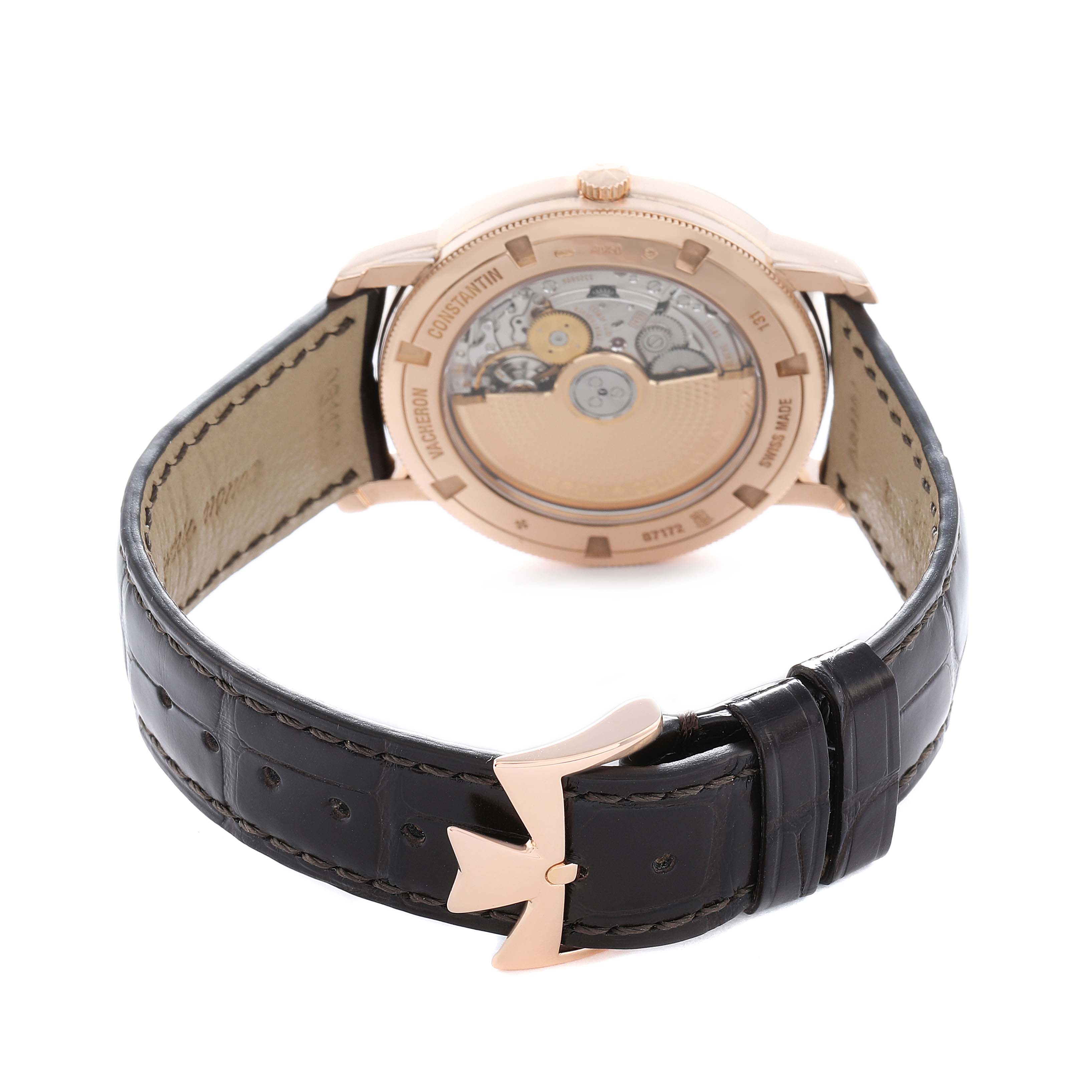 The Vacheron Constantin Traditionnelle 87172 Men
s Rose Gold Silver Dial watch is shown from the back, displaying its mechanical movement and black leather strap with a clasp.